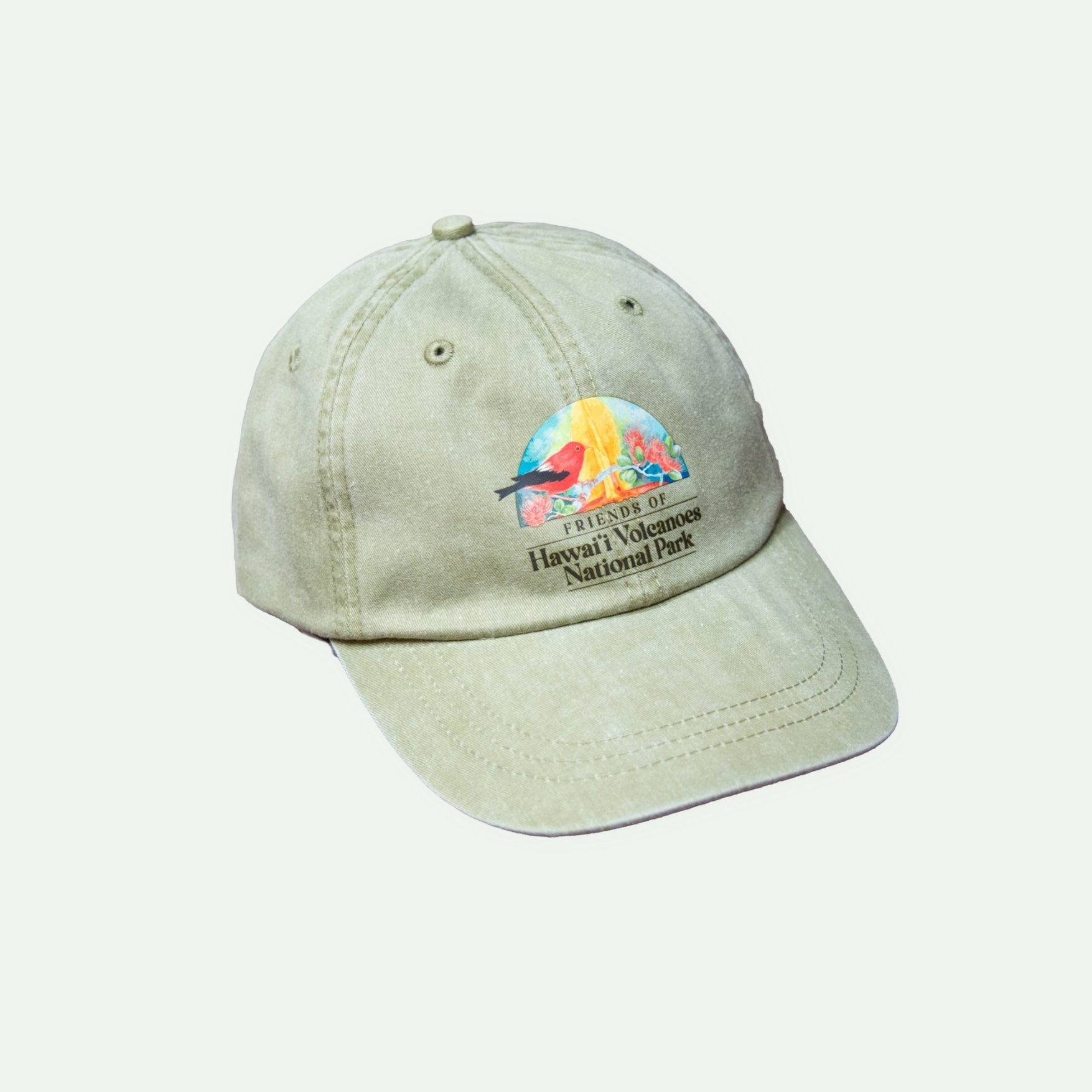Beige baseball cap with a colorful embroidered patch depicting a bird, flowers, and tropical scenery, and text that reads 'Friends of Hawaii Volcanoes National Park.'