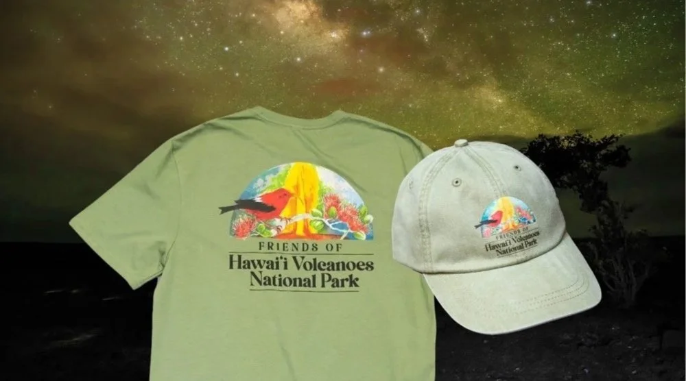 A green T-shirt and a beige baseball cap, both featuring a colorful logo of a bird and volcano, with text 'Friends of Hawaii Volcanoes National Park,' set against a starry night sky background.