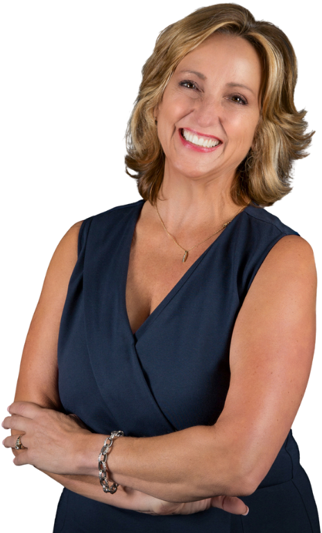 Chris Chaia smiling and wearing a navy sleeveless dress, with her arms crossed.