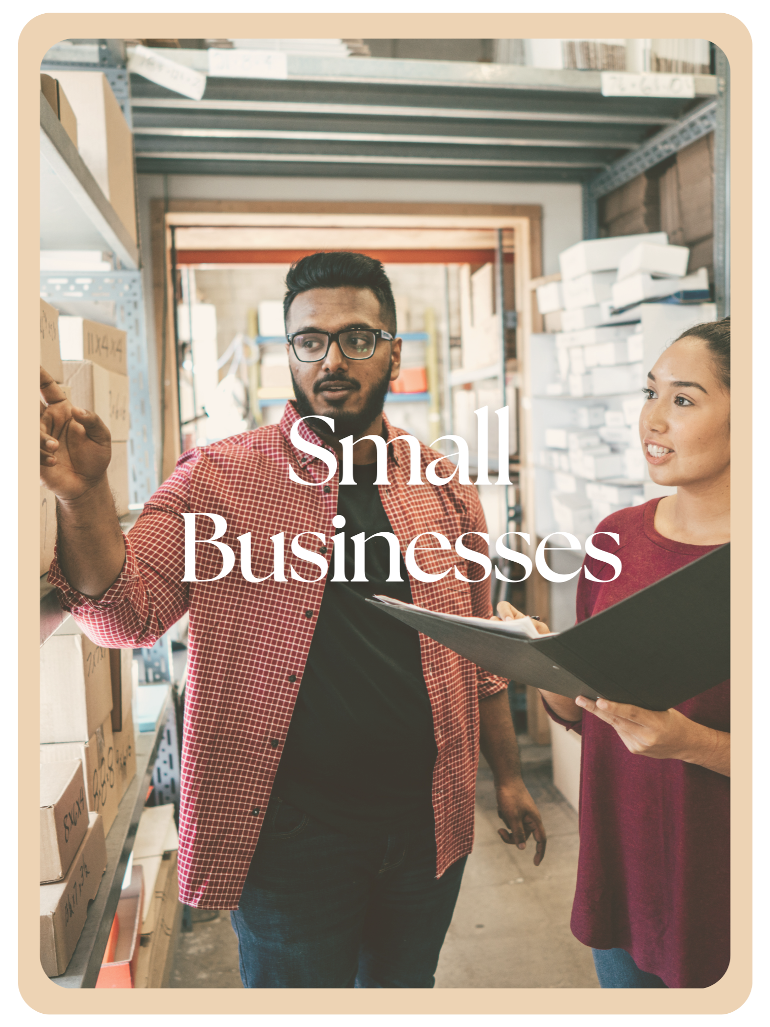 Two small business owners discuss inventory in a warehouse, with shelves of boxes around them.
