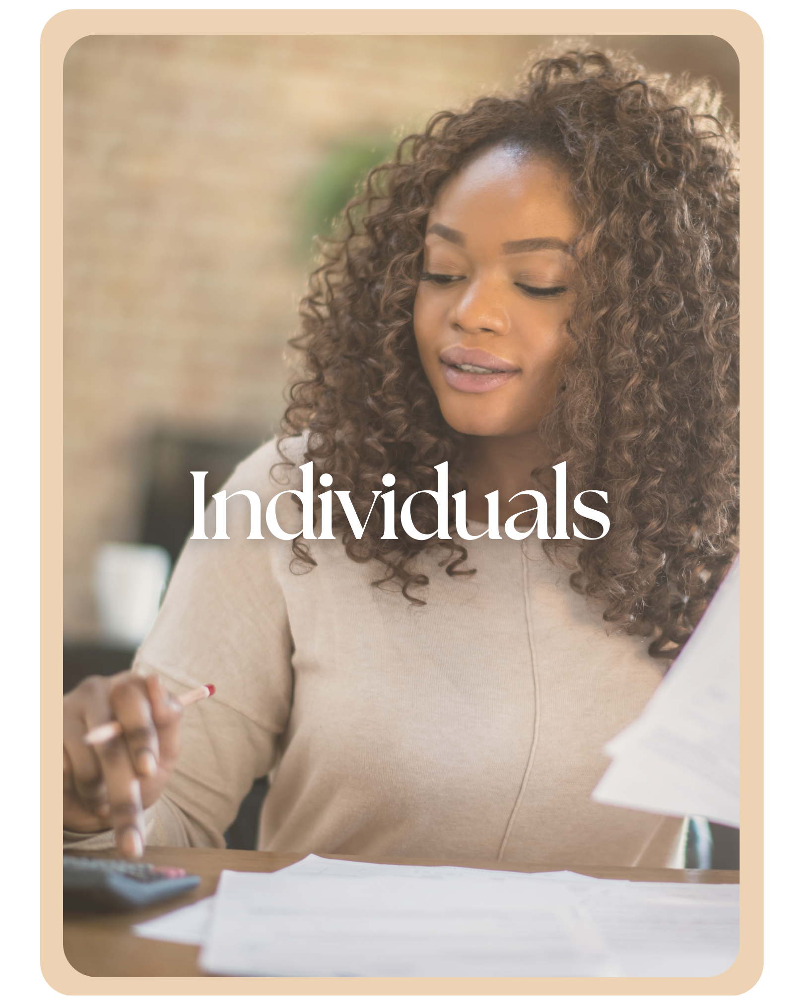 A woman with curly hair looks at documents on a table, holding a pen, with the word 'Individuals' written across the front.