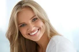 A smiling woman with long blonde hair and blue eyes