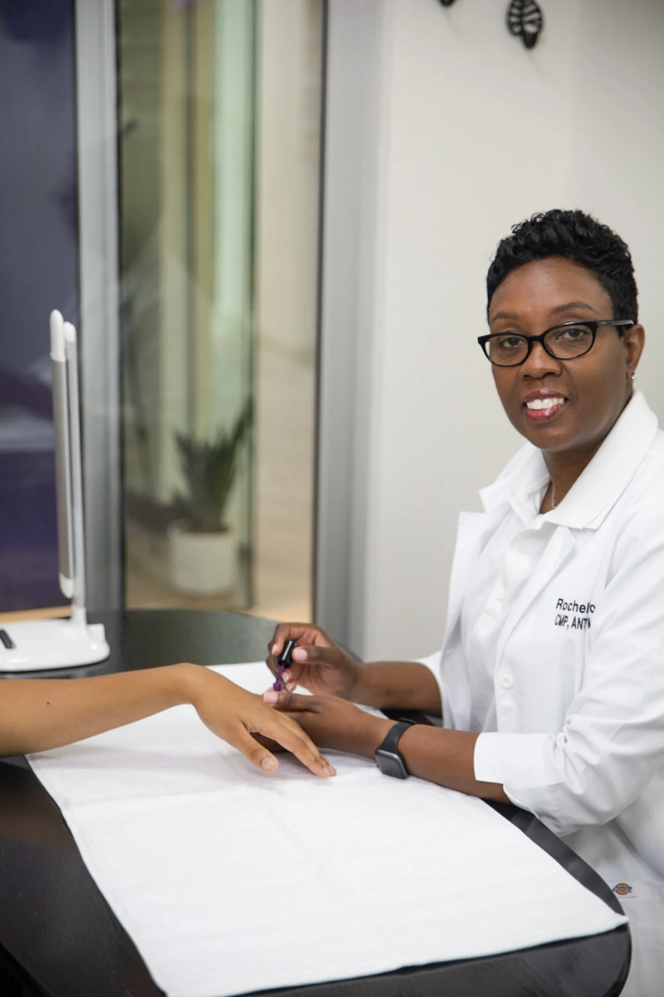 A nurse drawing blood from a patient's arm in a clinical setting.