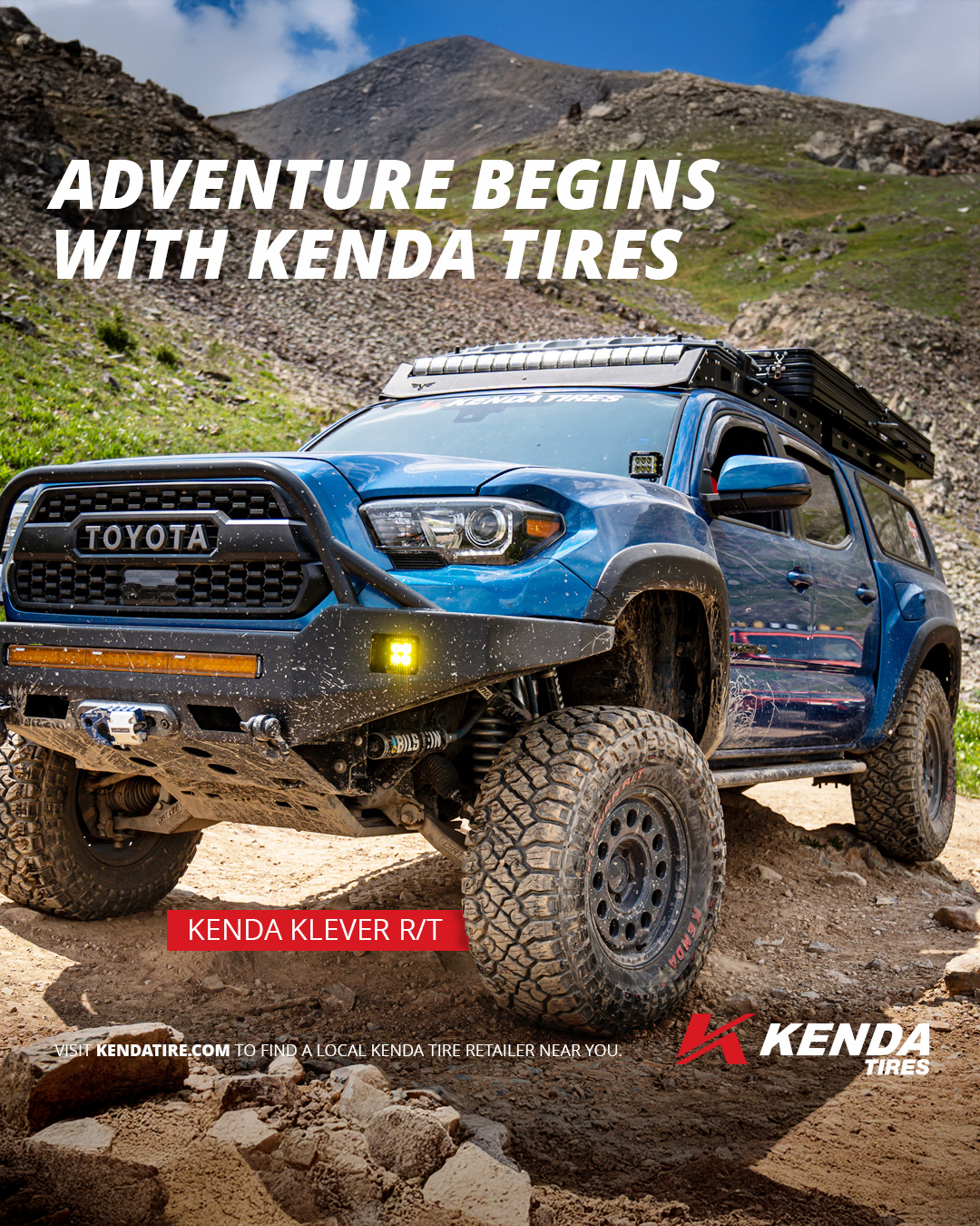A blue Toyota off-road vehicle on a rocky dirt trail in a mountainous area with a clear sky, featuring Kenda tires and a front bumper guard. Text overlay reads 'Adventure begins with Kenda tires' and 'Kenda Klever R/T'.