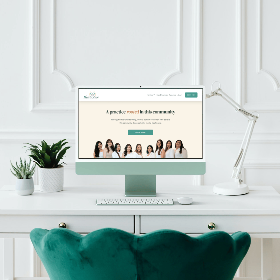 Computer on white desk displaying a counseling center's website.
