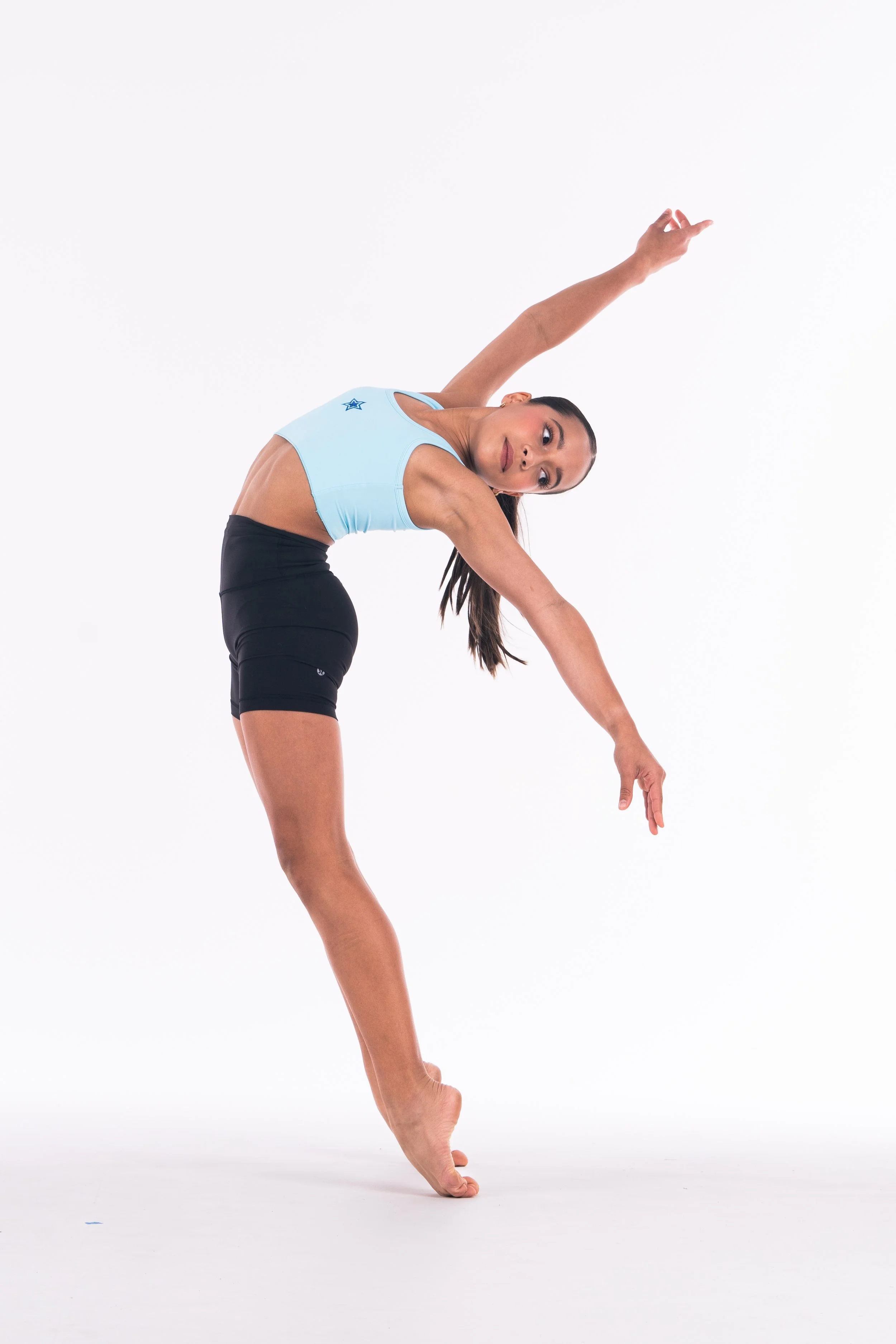 Female dancer performing a contemporary dance pose for Starbound Entertainers Festival promotional photo against a white background.