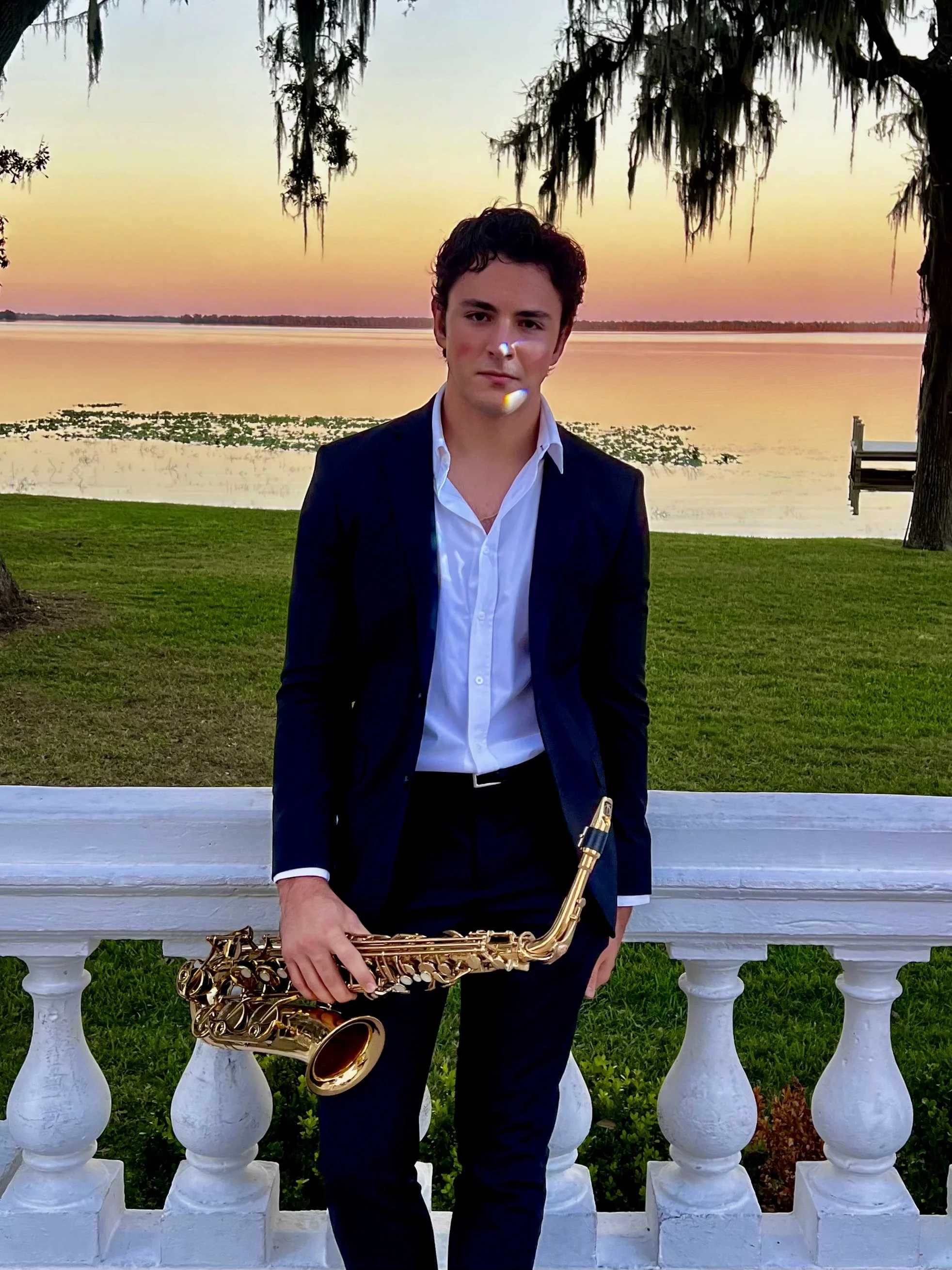 Vincent Imperial Jr., luxury wedding saxophonist, holding saxophone at an elegant Florida venue