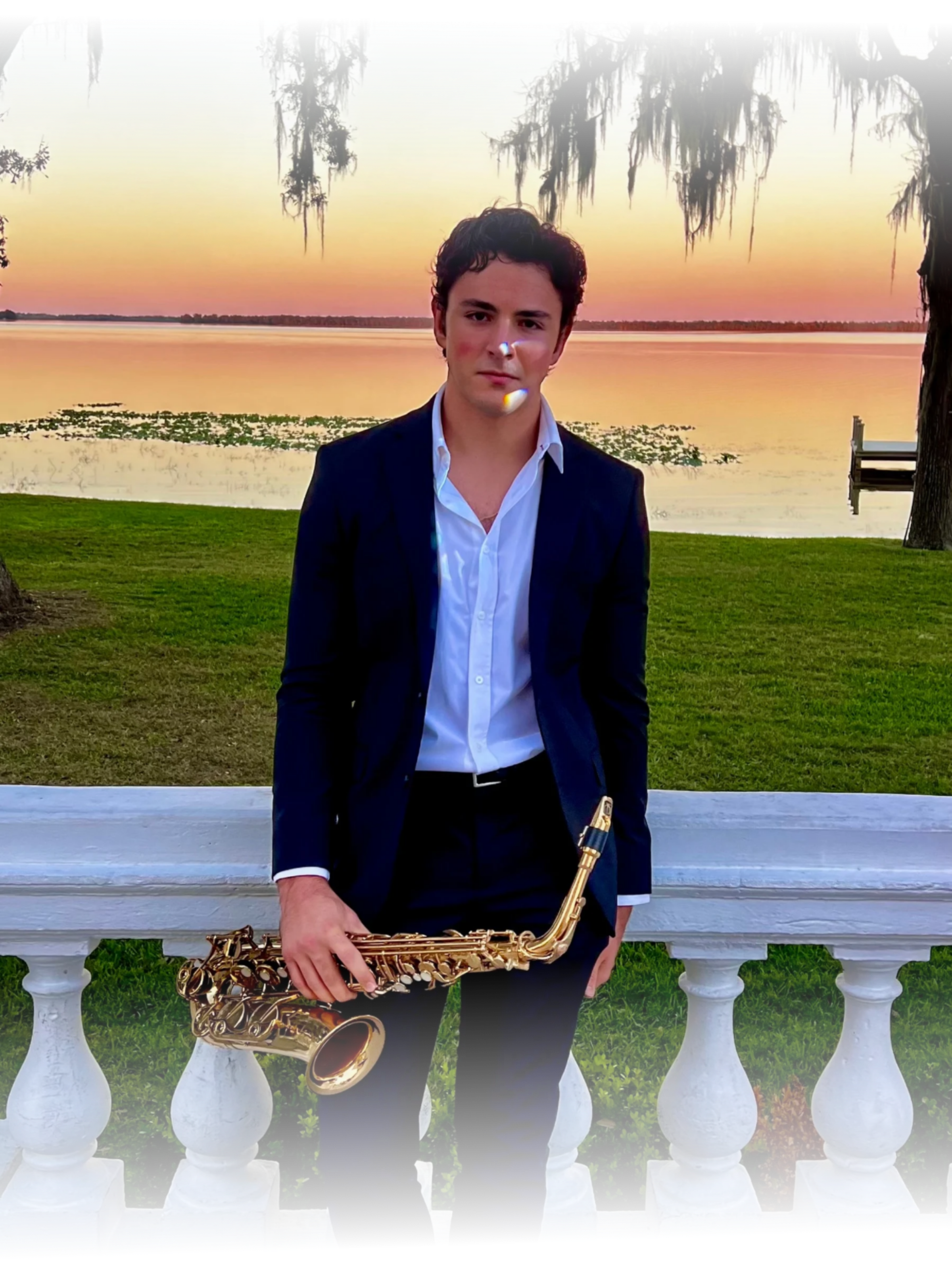 Wedding saxophonist Vincent Imperial Jr holding saxophone at sunset in Florida