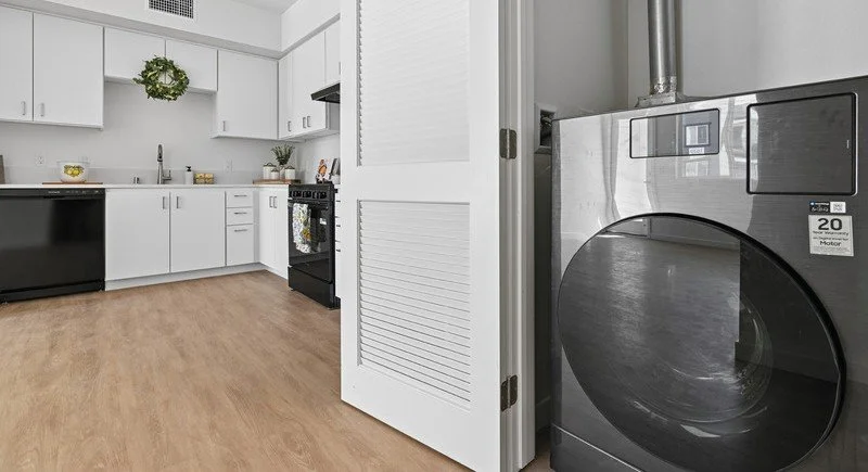 View of kitchen and laundry facilities in apartment