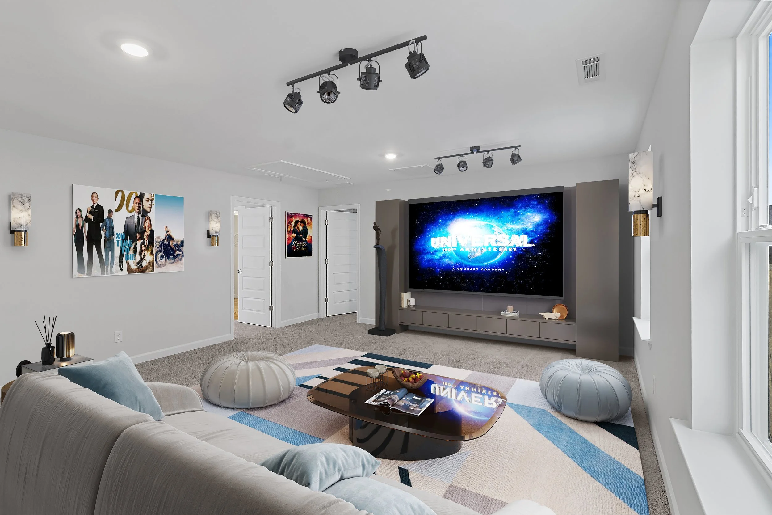 Modern living room with white walls, a large flat-screen TV displaying the Universal logo, a beige couch with pillows, a multi-colored rug, two pod-like chairs, wall-mounted light fixtures, and movie posters on the wall.