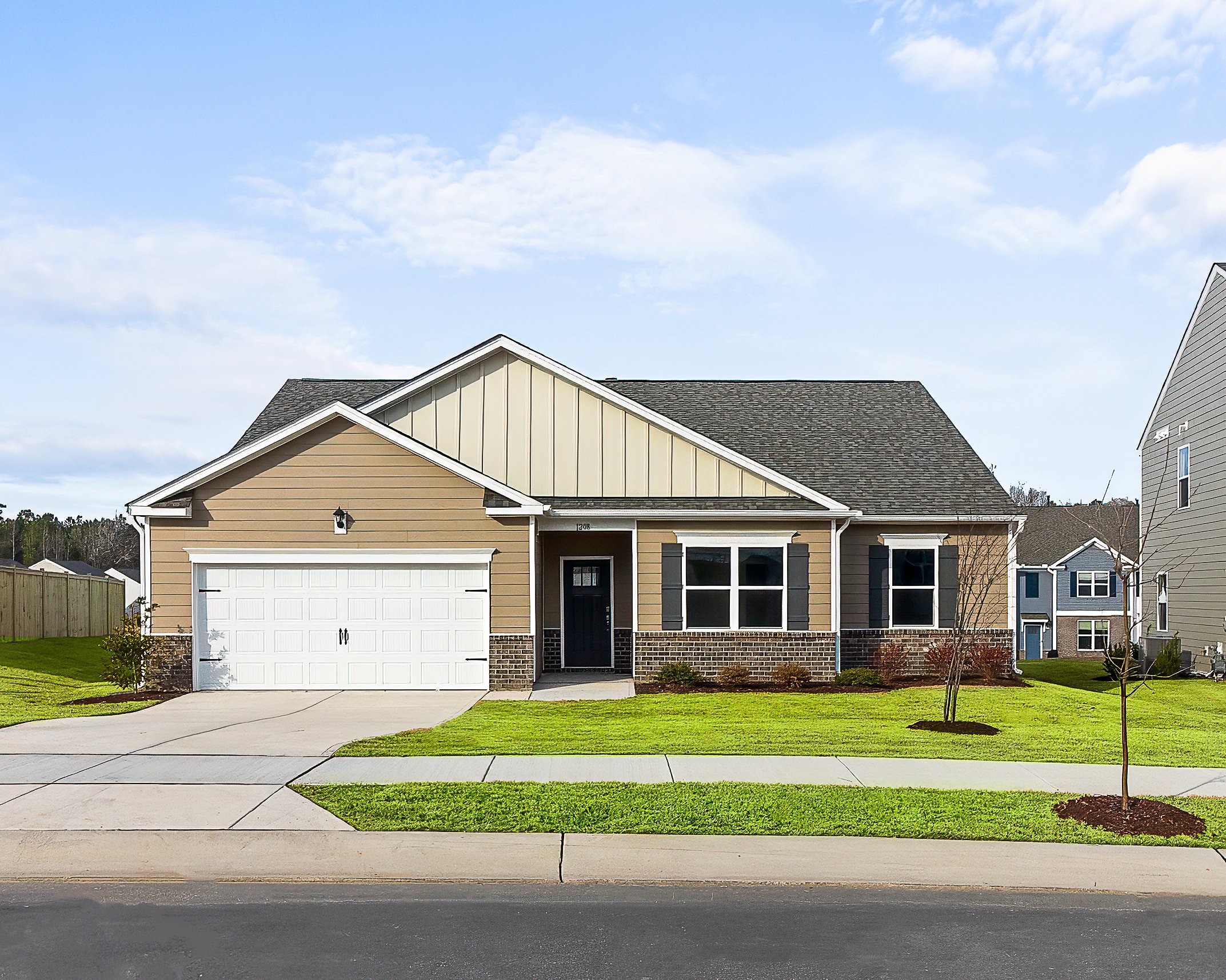 Front view of a modern suburban house with beige siding, white garage door, black front door, and two windows with black shutters, surrounded by a well-maintained lawn and a sidewalk.