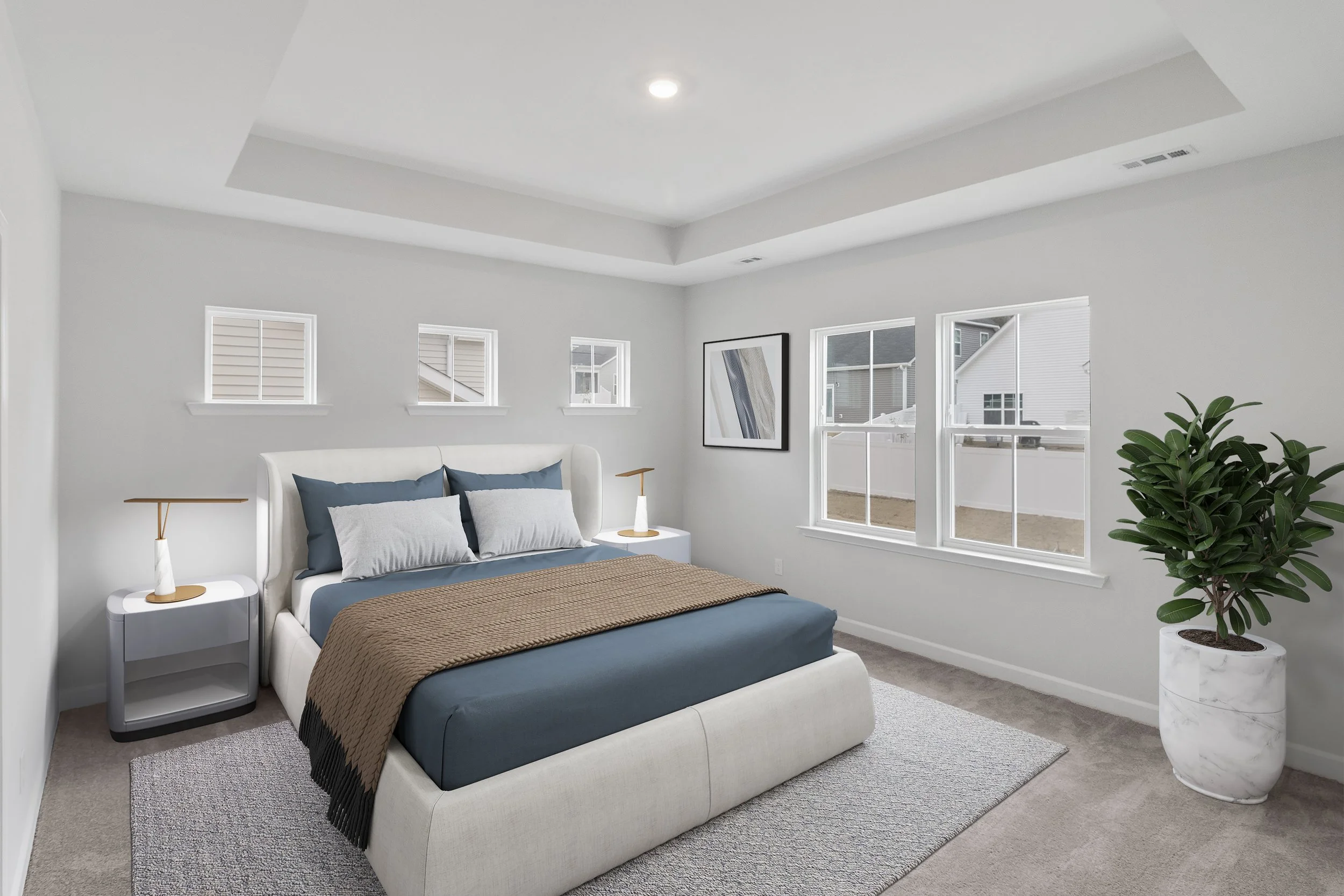 A minimalist bedroom with white walls, a large bed with blue and gray bedding, modern white nightstands with gold accents, a large potted plant in a marble planter, and a window showing neighboring houses.