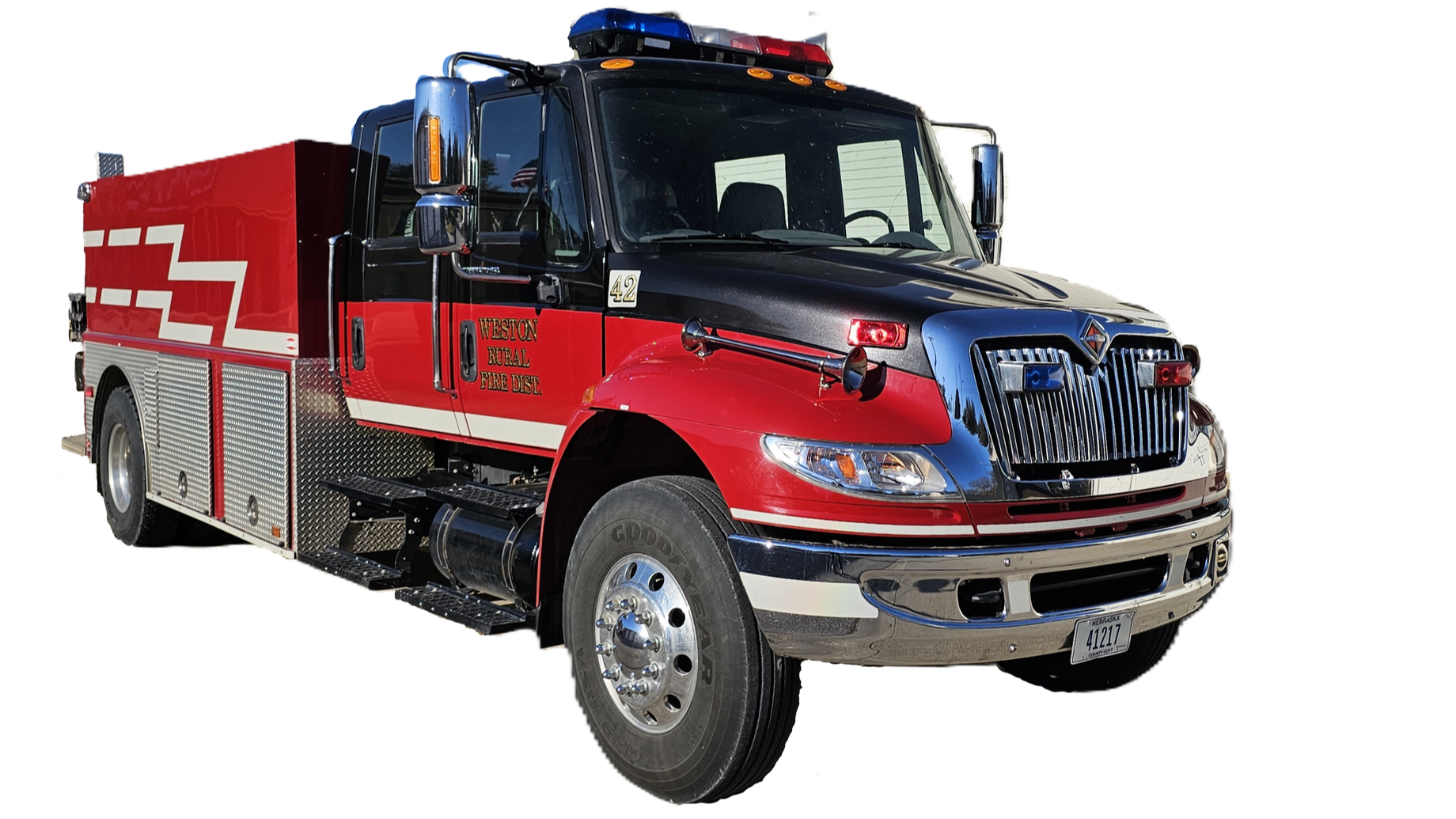 Red and black fire truck with chrome accents, emergency lights on top, and labeled 'Weston Rural Fire Dist.'