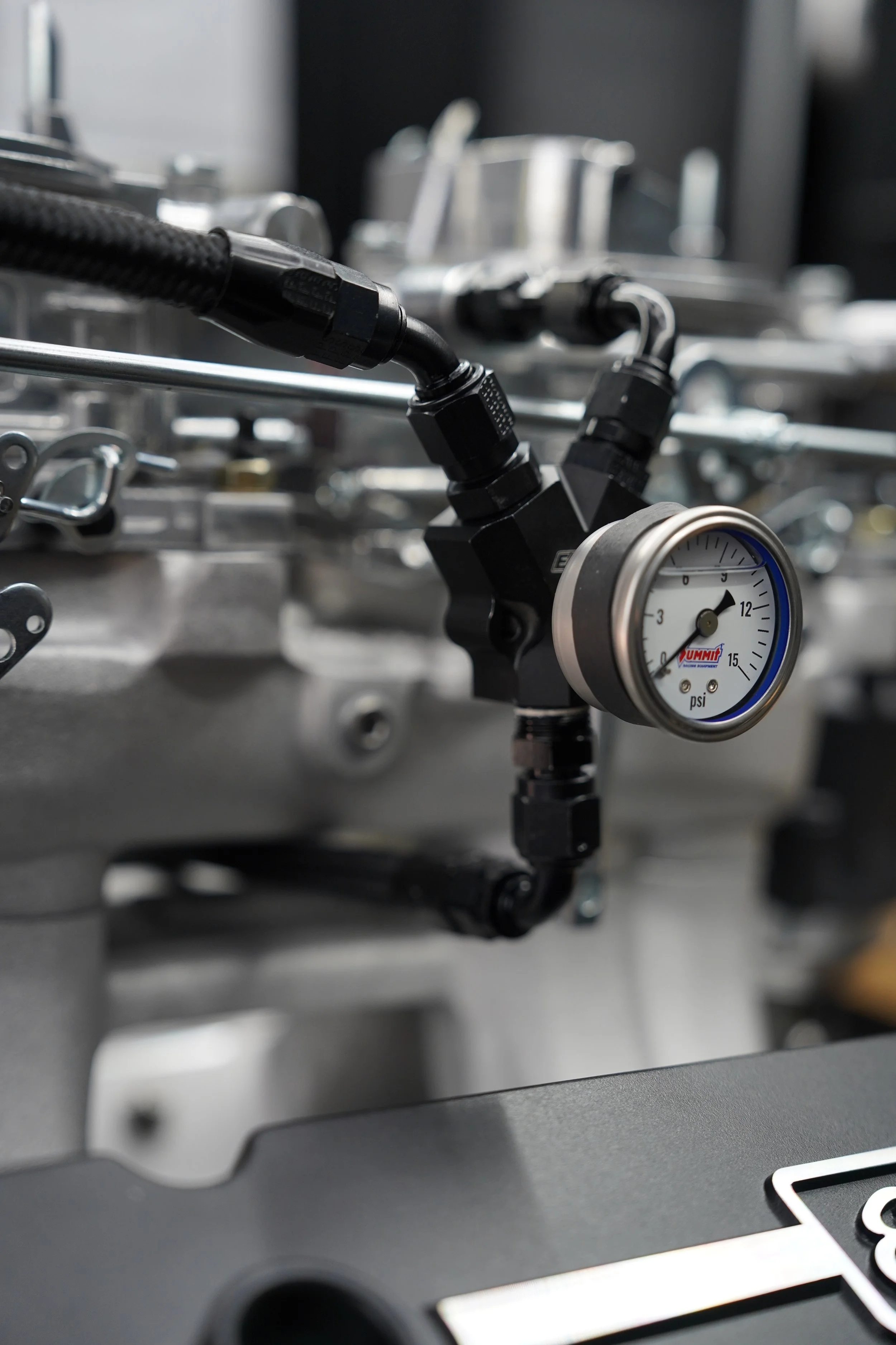 Close-up of mechanical equipment with pressure gauge on metallic machinery.