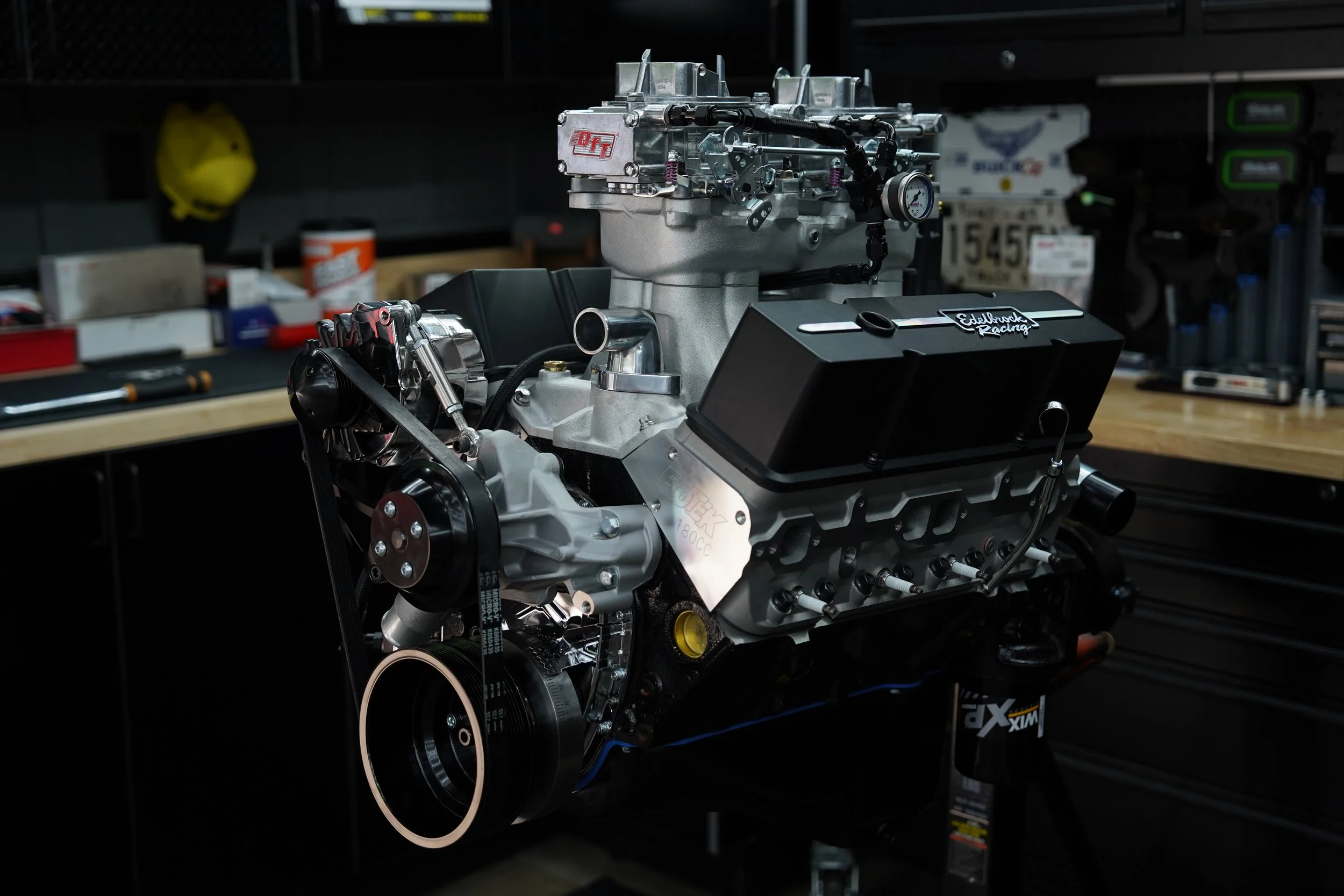 A car engine on a workbench in a garage.