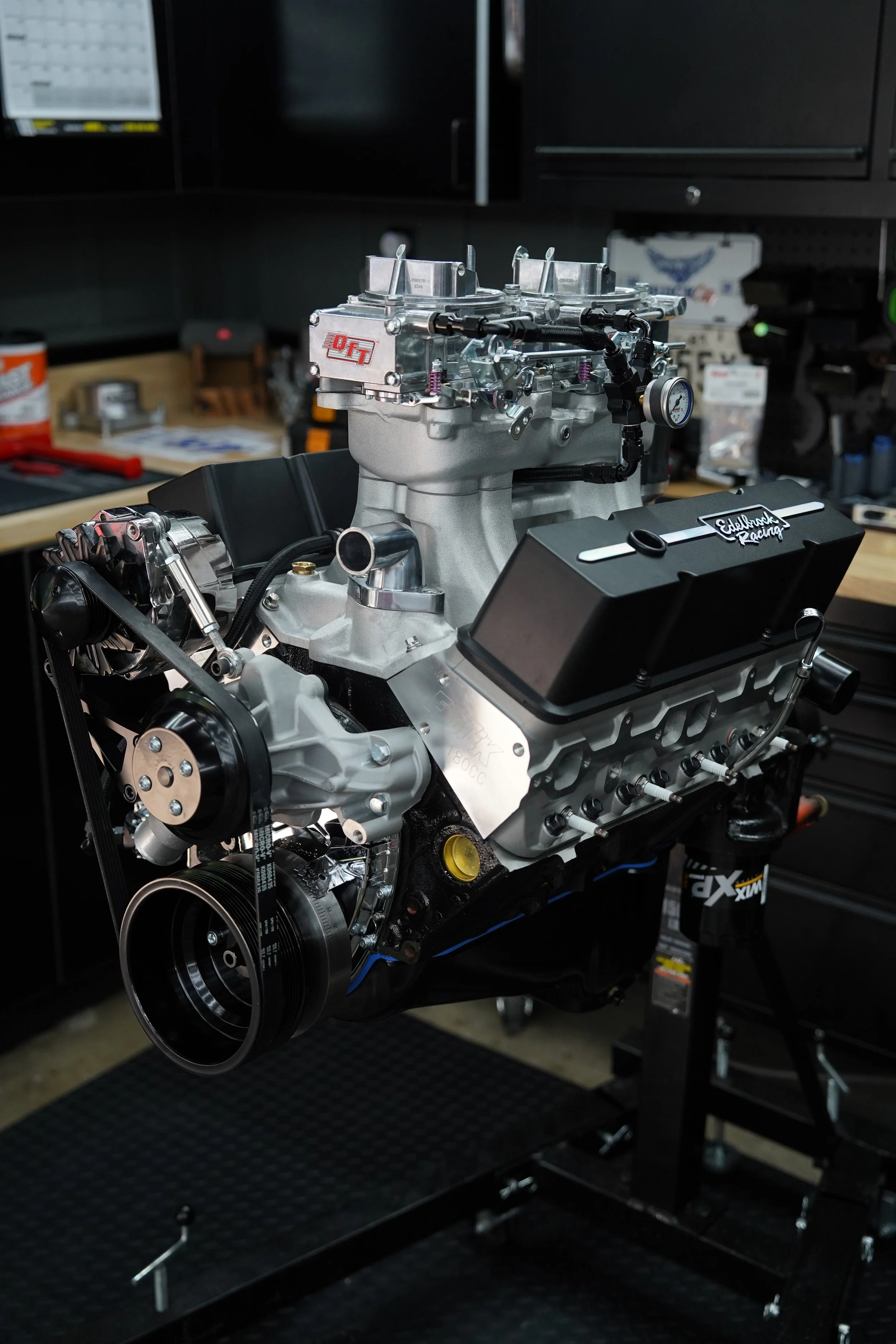 Car engine mounted on a stand in a workshop.