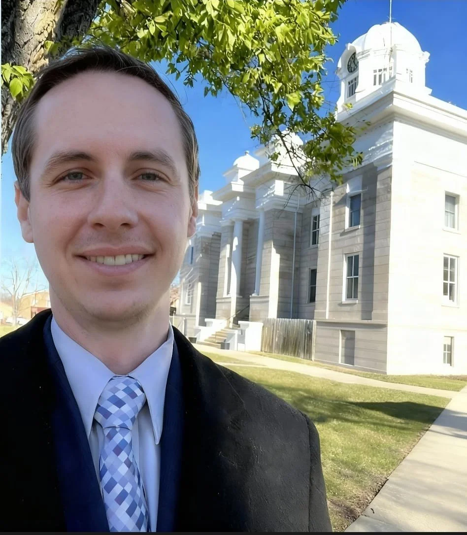 Evan in front of a courthouse