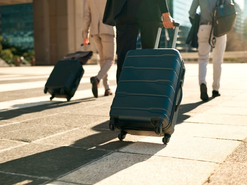 suitcases rolling on pavement