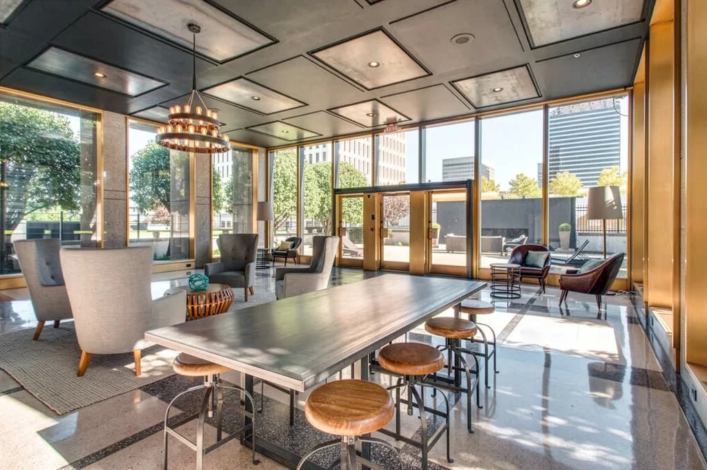 Lobby with large windows and furniture.