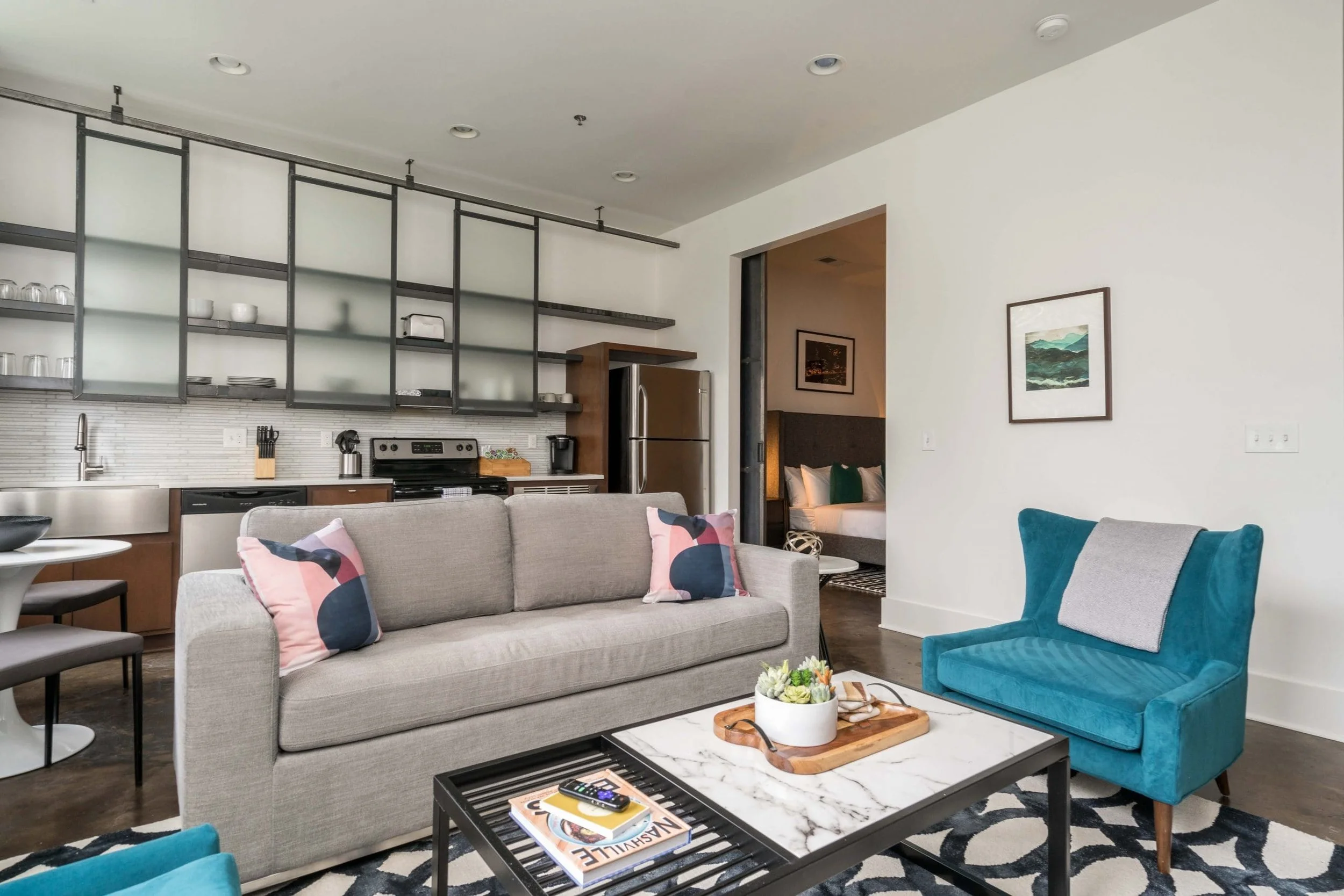 Empty room with couches and kitchenette