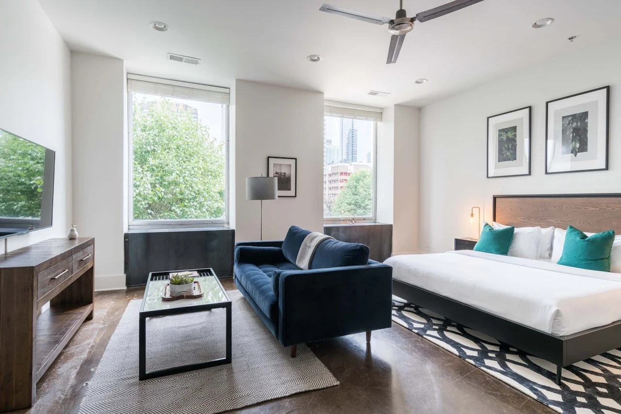 Living room and bedroom with two windows.