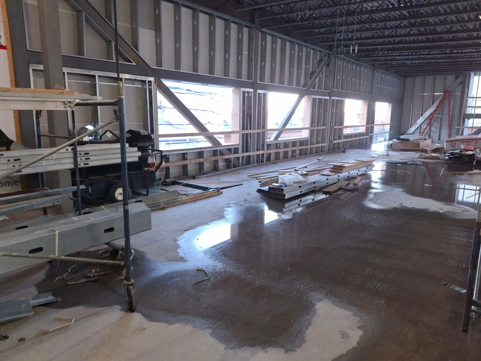 Interior of a building under construction with exposed metal framing.
