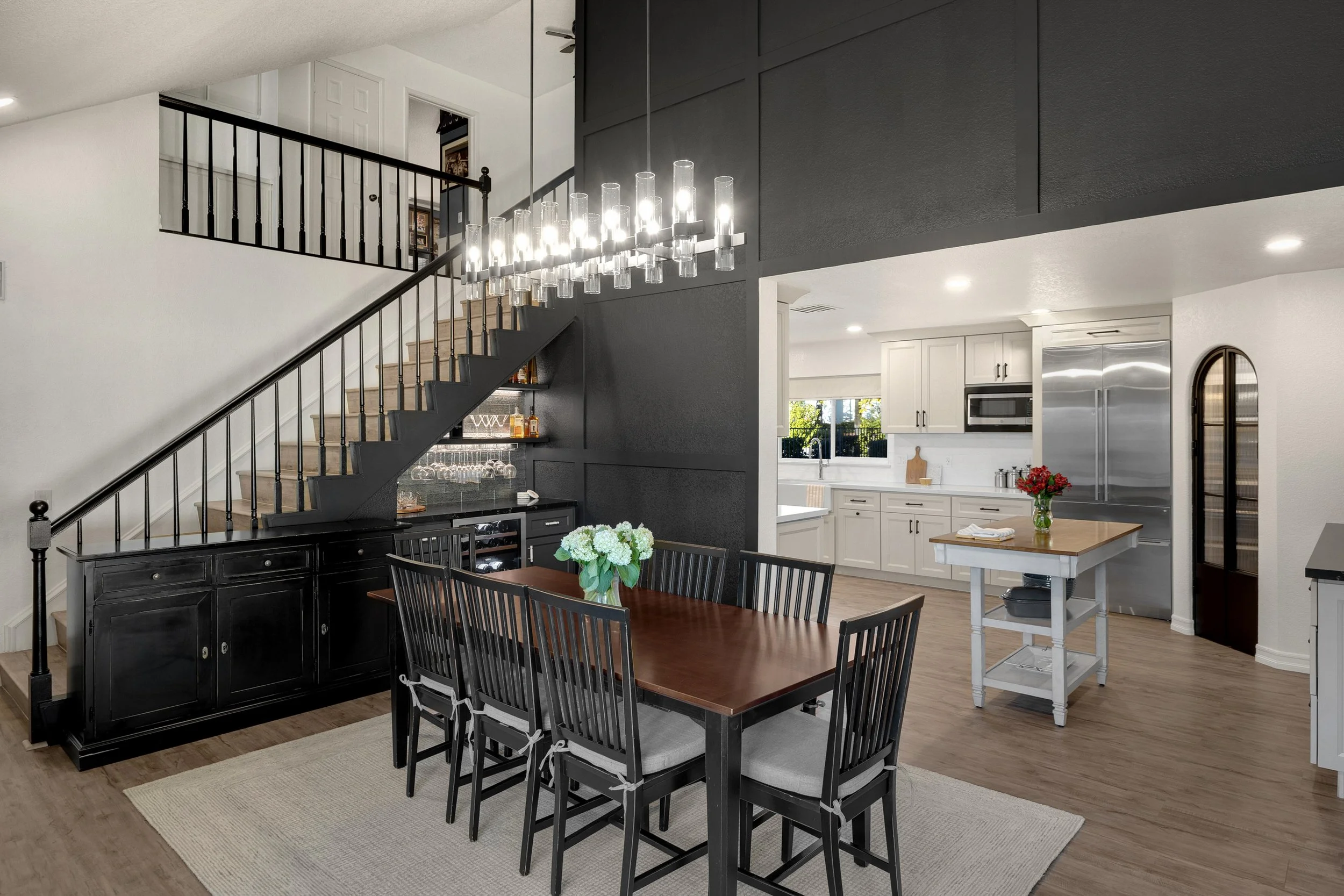 Laurie’s customers, Mariana and Carmen holding hands on a green lawn on their wedding day.