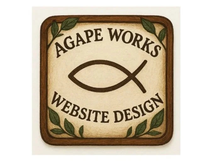 Wooden sign with the text 'Agape Works Website Design' and a fish symbol, surrounded by green leaves.