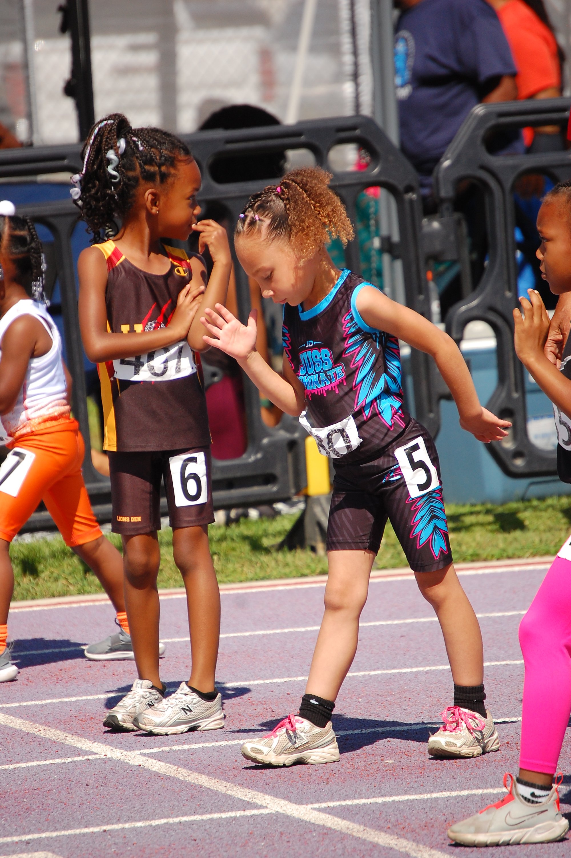 Youth sprinter competing during a California track & field meet captured by Najee Smith Creative
