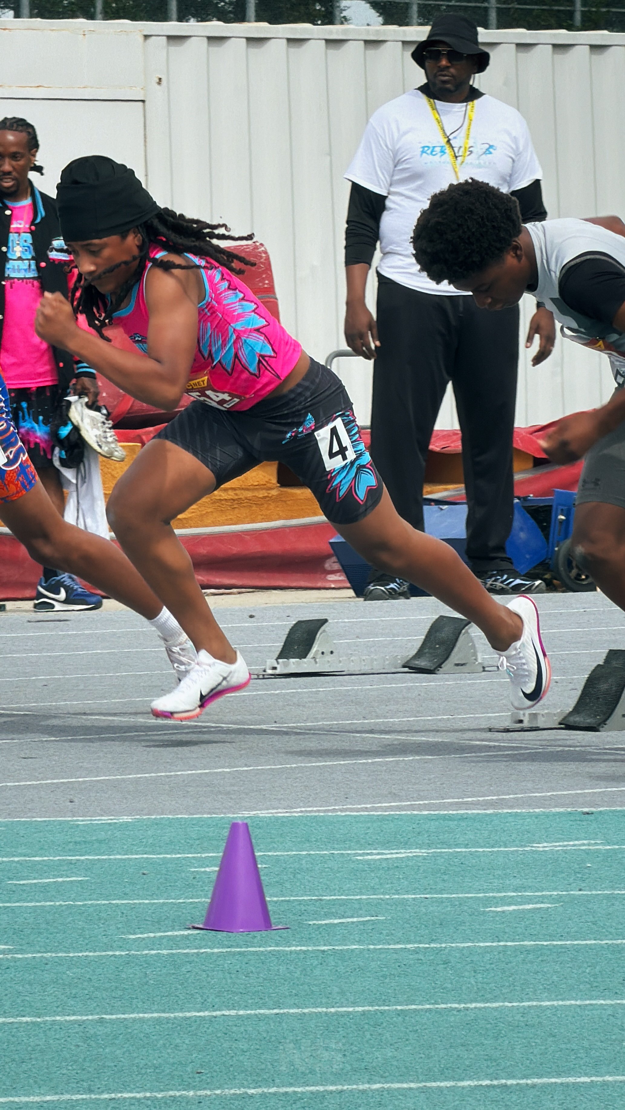 Youth sprinter competing during a California track & field meet captured by Najee Smith Creative.