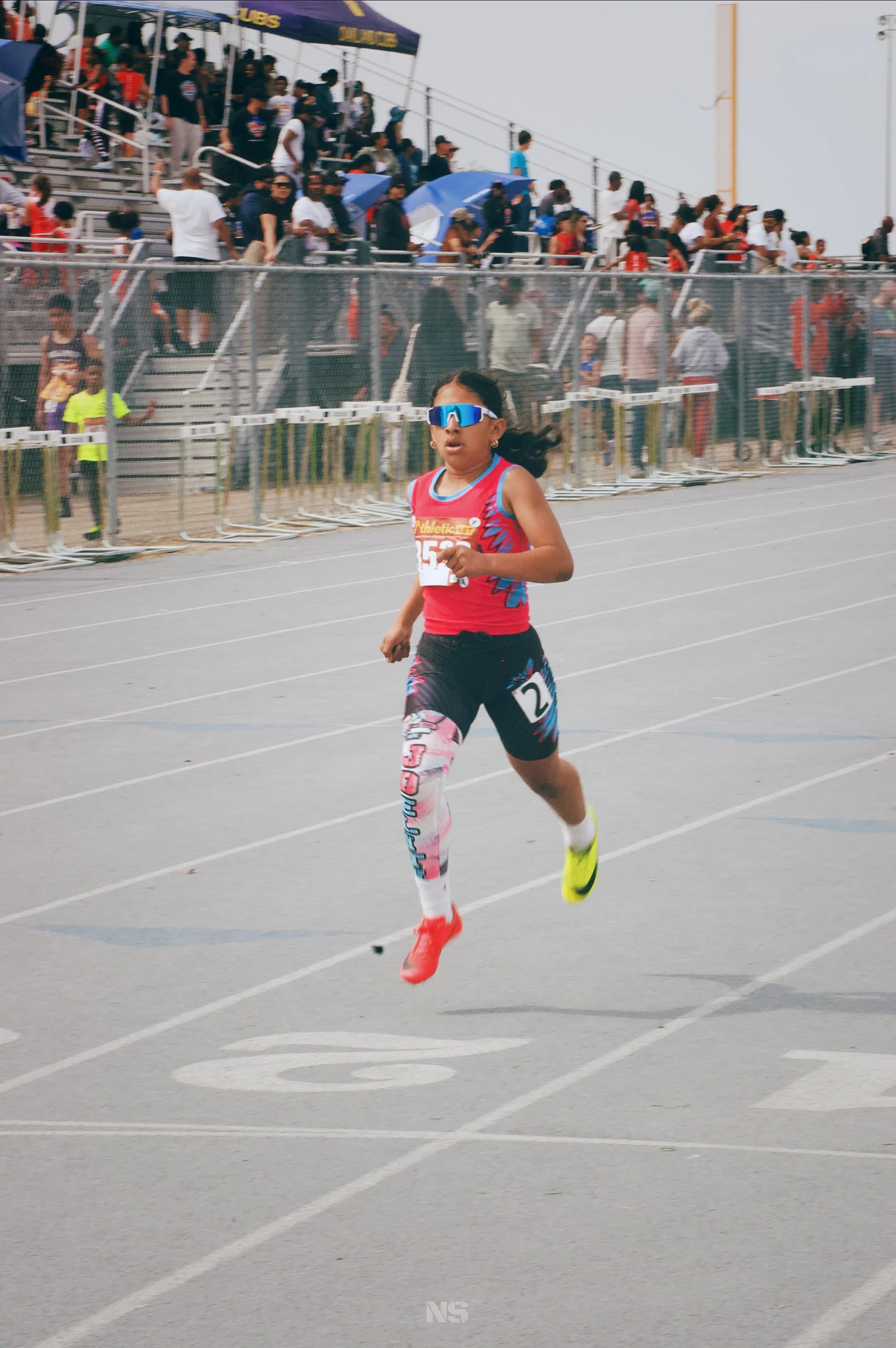 Professional track meet photography showcasing athlete performance and speed.