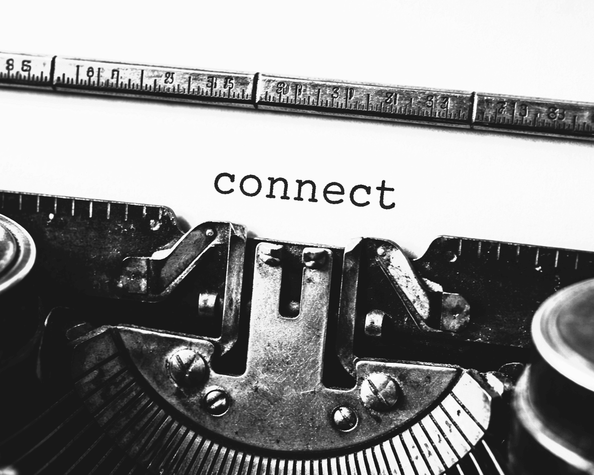 A close-up view of a vintage typewriter with the word 'connect' typed on a piece of paper.