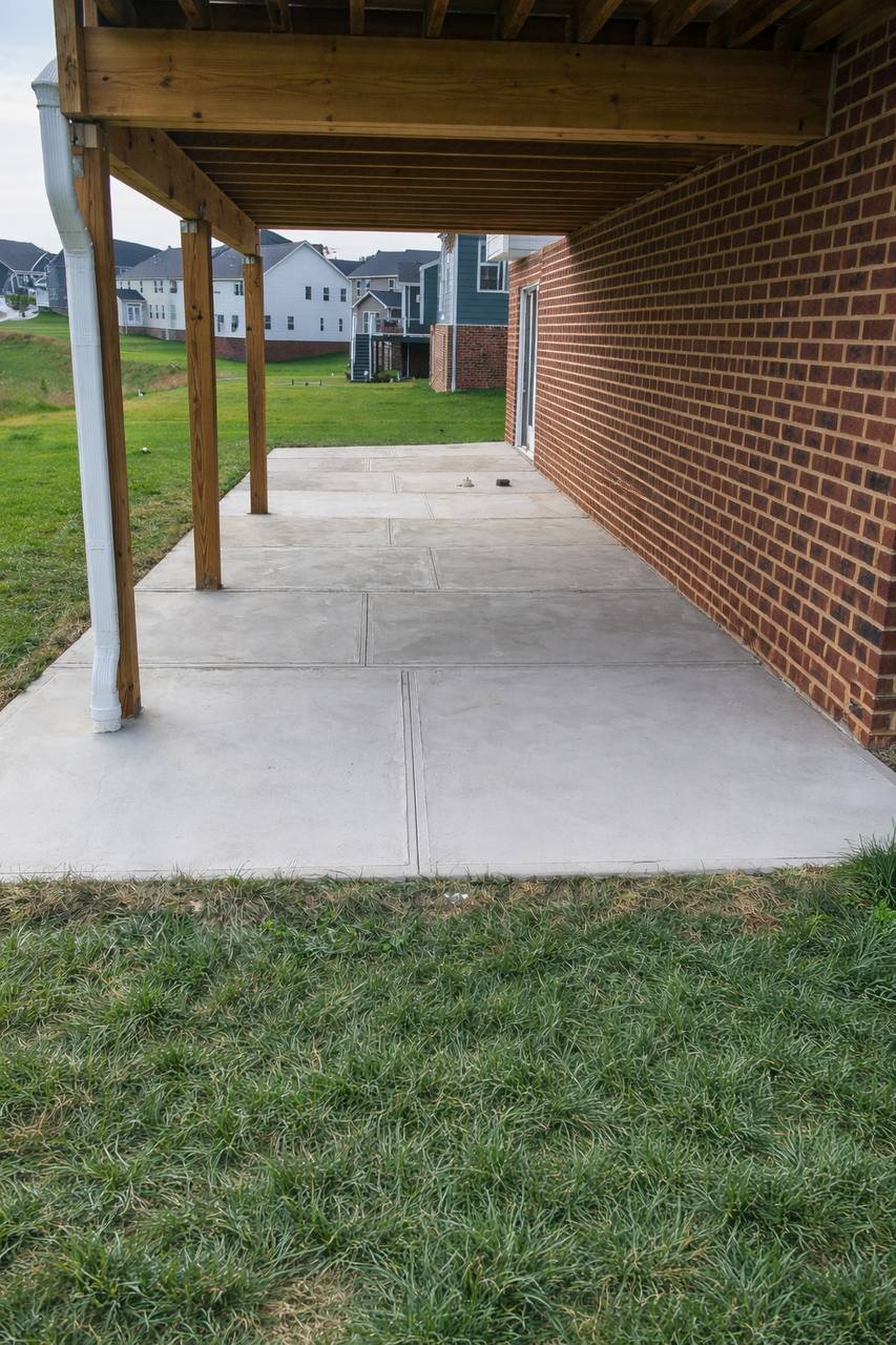 Backyard concrete patio under deck installation in Pittsburgh PA