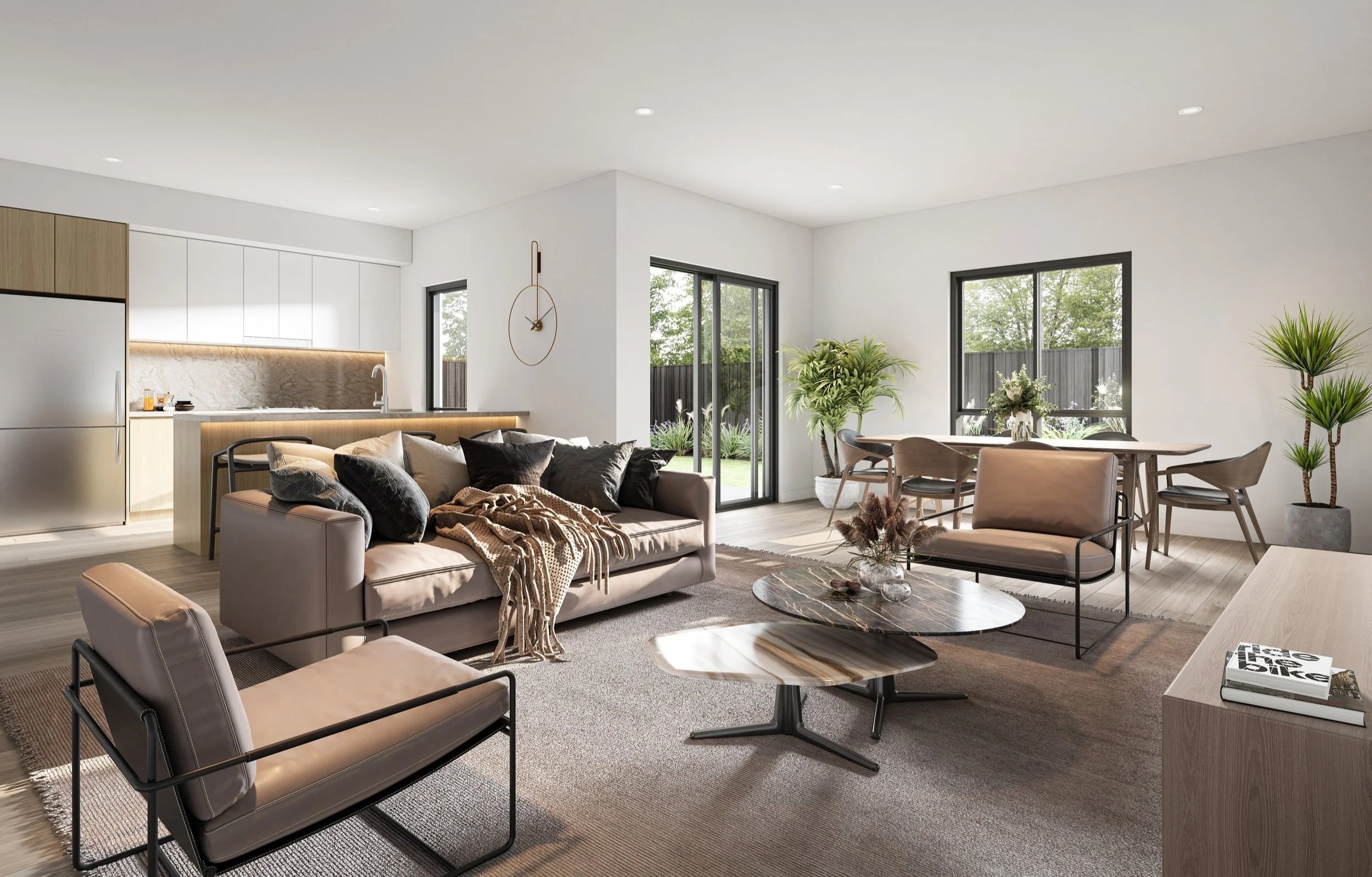 Open-concept living room with beige sofas, black and beige armchair, round marble coffee tables, beige and black pillows, cozy throw blanket, dining area with wooden table and chairs, potted plants, large windows, sliding glass door to backyard, kitchen with white cabinets and marble backsplash.