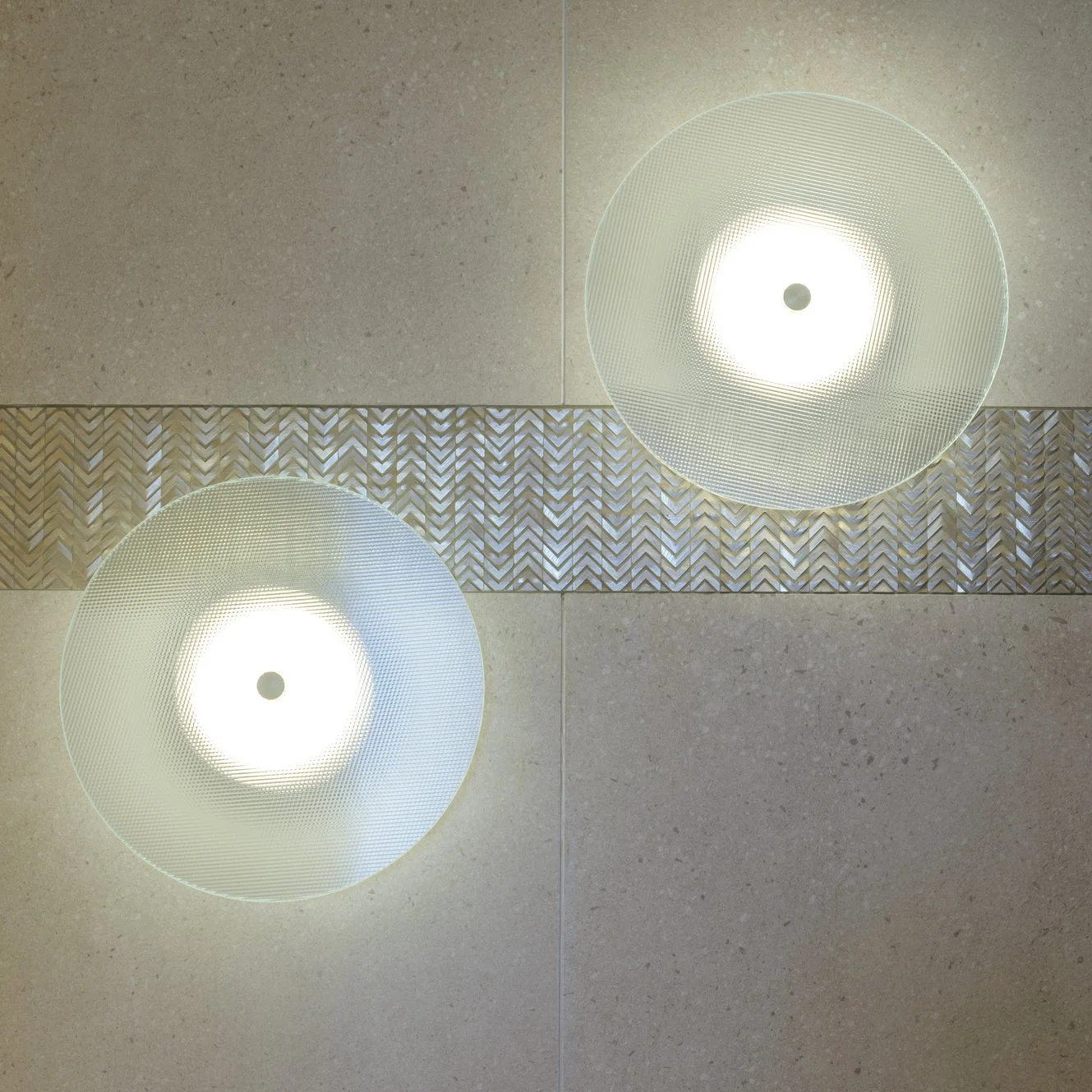 Potts Point Unit 2024 — high-end apartment renovation in Sydney featuring bespoke joinery, herringbone timber flooring with brass inlay, integrated lighting and a cohesive open-plan kitchen, living and dining space.