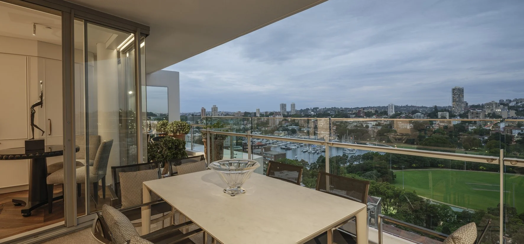 Potts Point Unit 2024 — high-end apartment renovation in Sydney featuring bespoke joinery, herringbone timber flooring with brass inlay, integrated lighting and a cohesive open-plan kitchen, living and dining space.