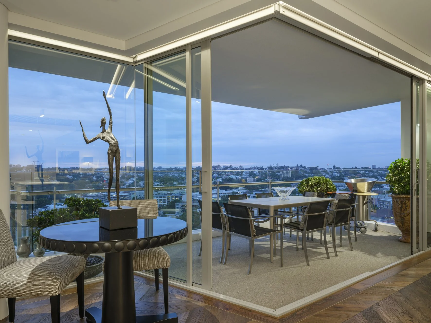 Potts Point Unit 2024 — high-end apartment renovation in Sydney featuring bespoke joinery, herringbone timber flooring with brass inlay, integrated lighting and a cohesive open-plan kitchen, living and dining space.