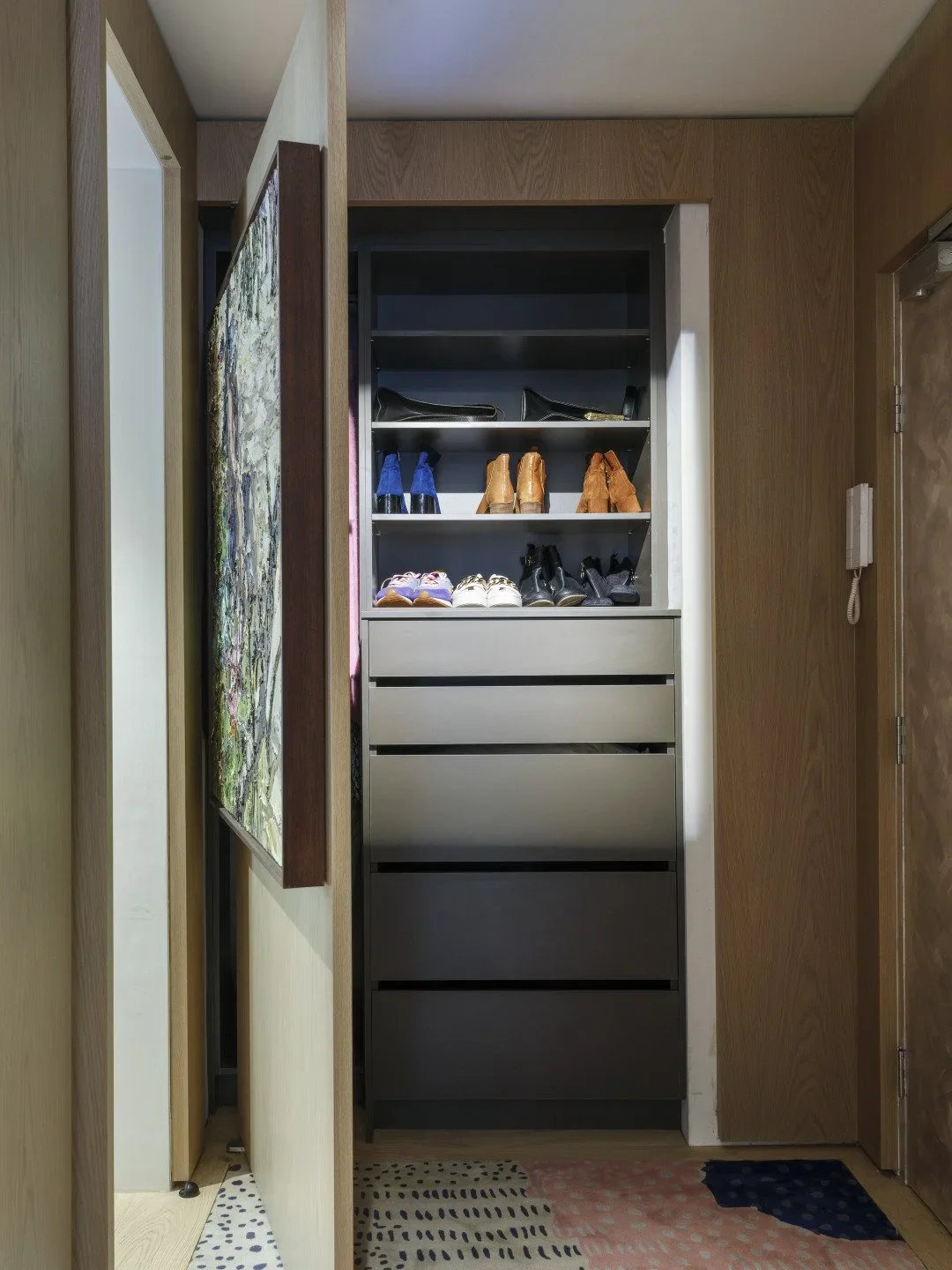 Closet with shoes and handbags on shelves.