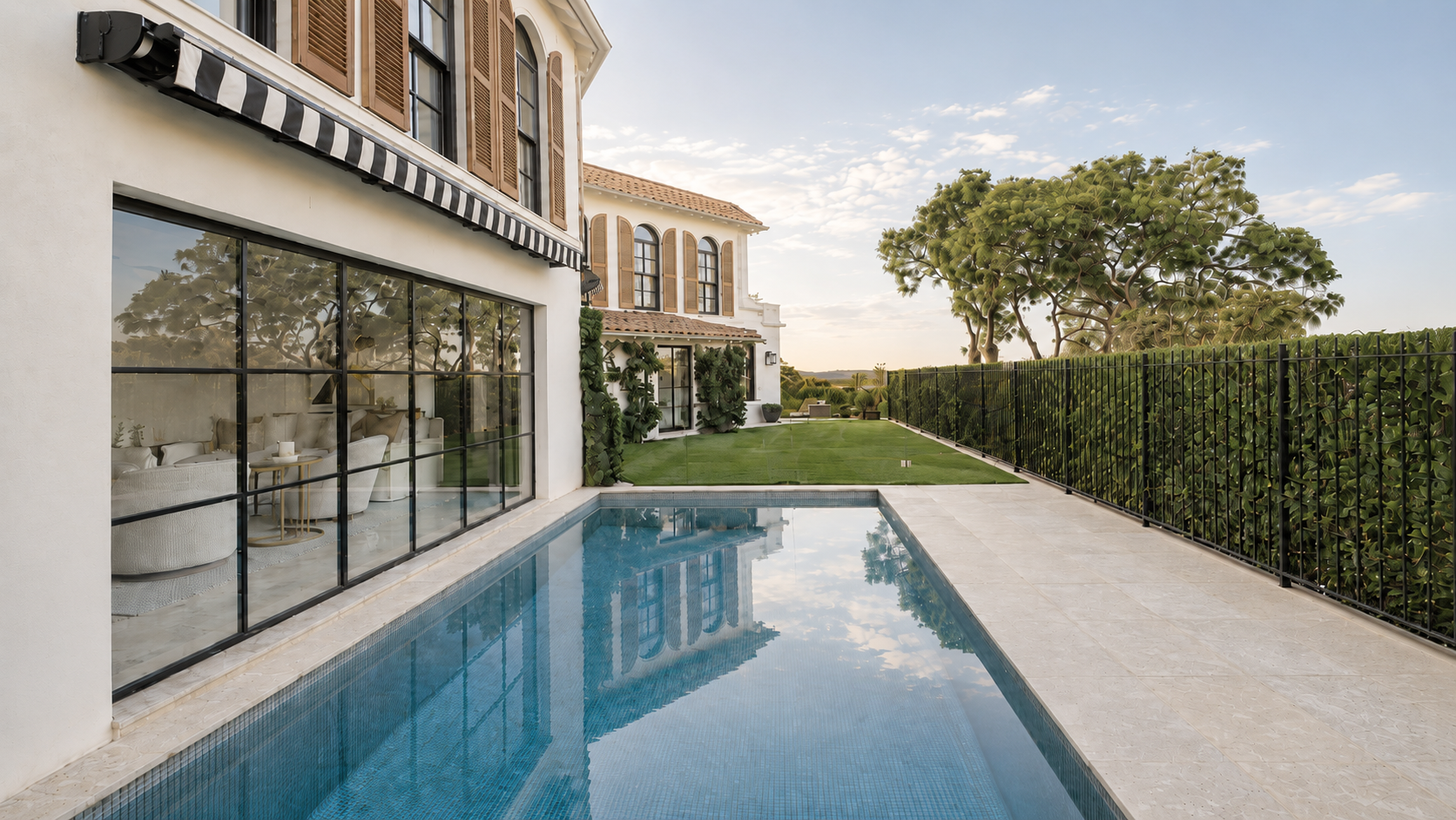 Vaucluse House exterior with swimming pool, black-framed glazing, timber shutters and Mediterranean-style architecture.