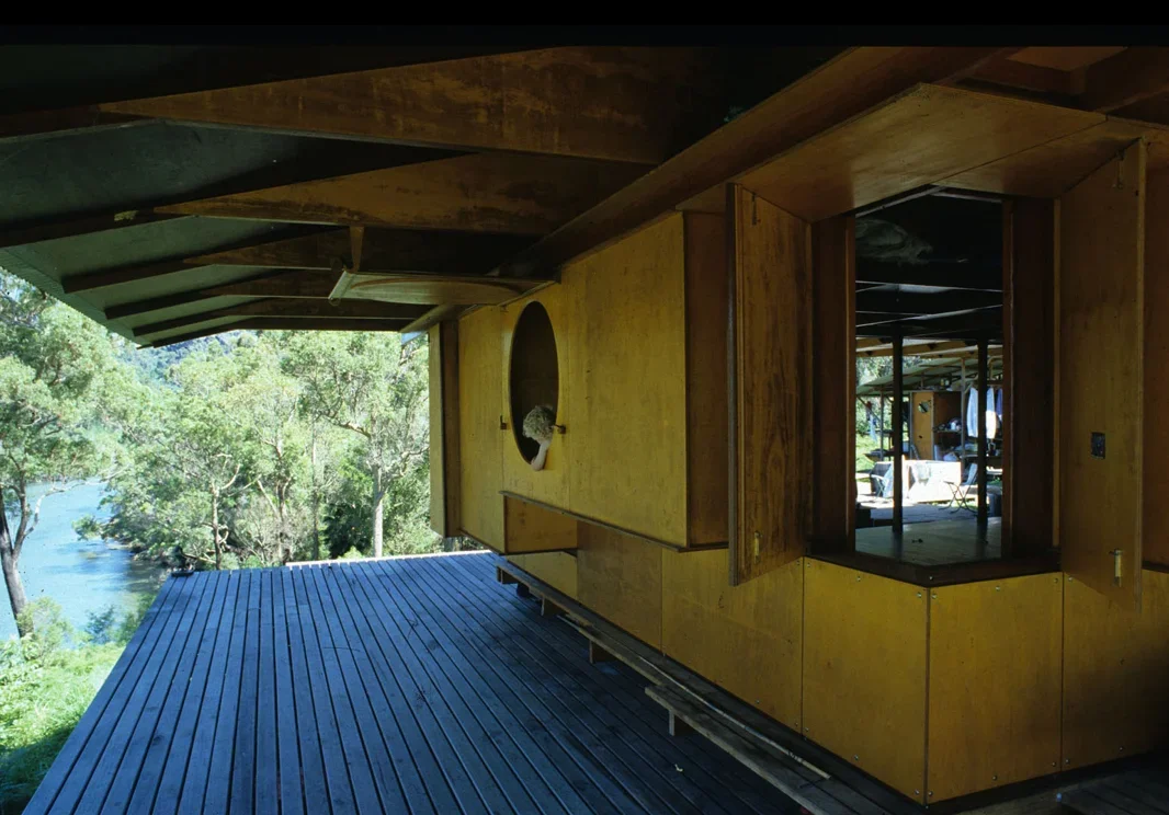 Covered deck and timber façade of Lovett Bay House, showing the lightweight construction and sheltered outdoor living space.