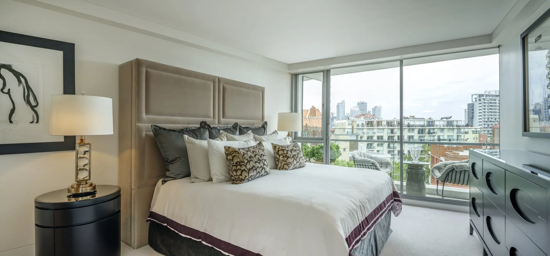 Potts Point Unit 2024 — high-end apartment renovation in Sydney featuring bespoke joinery, herringbone timber flooring with brass inlay, integrated lighting and a cohesive open-plan kitchen, living and dining space.