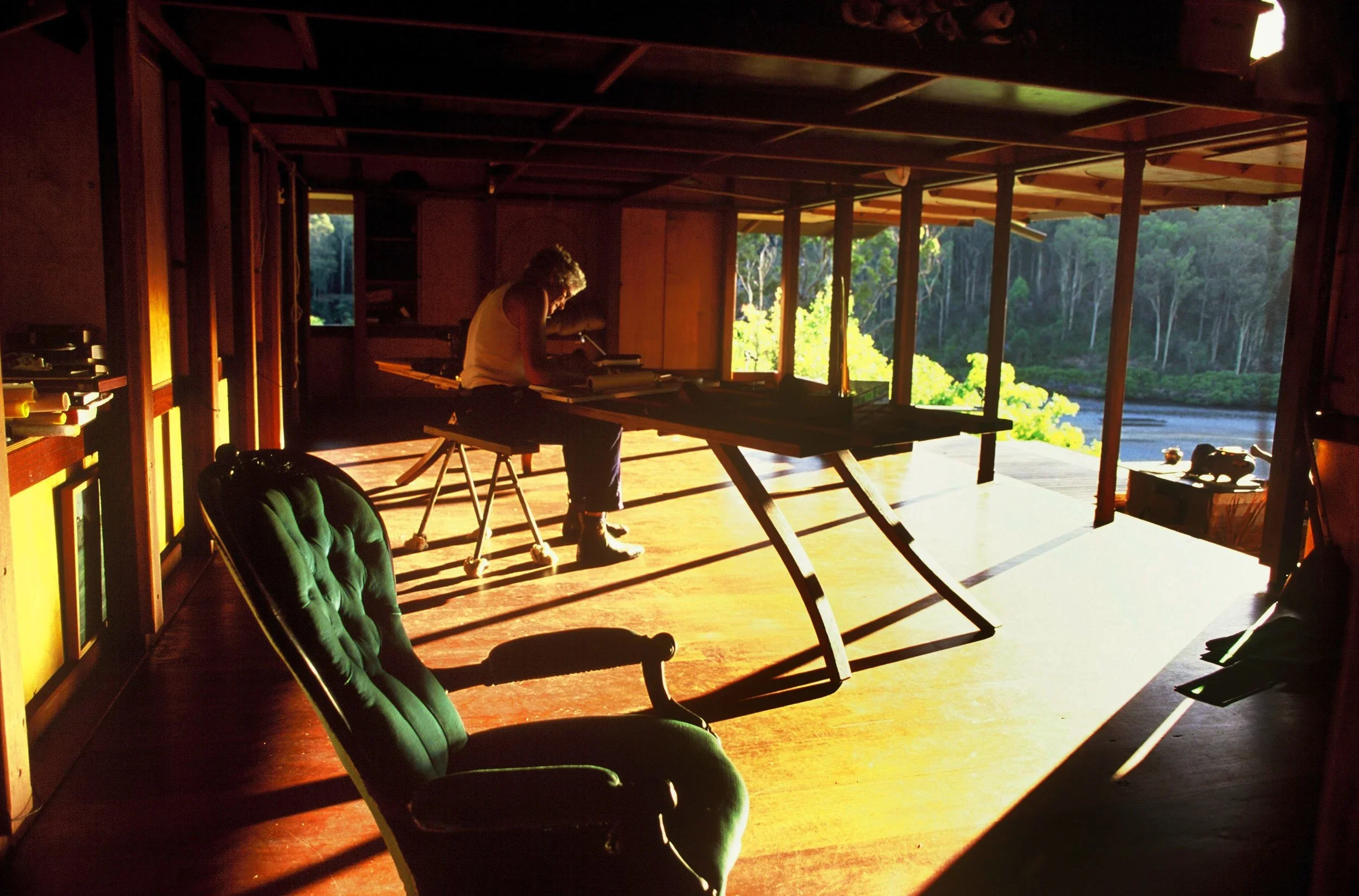 Interior of Lovett Bay House with warm timber floors, open living space and views across Pittwater, designed by Richard Leplastrier.