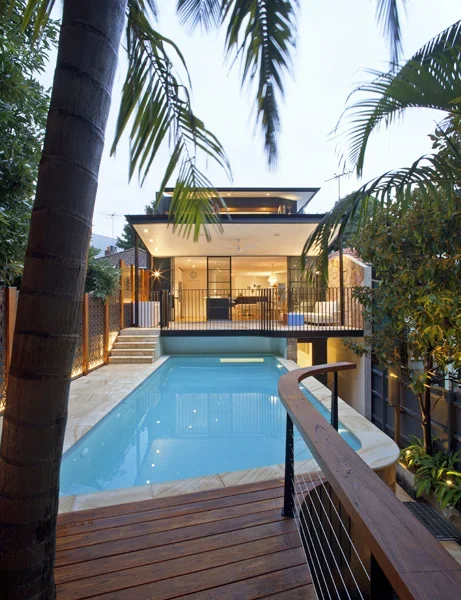 Modern house with a swimming pool and lush tropical plants