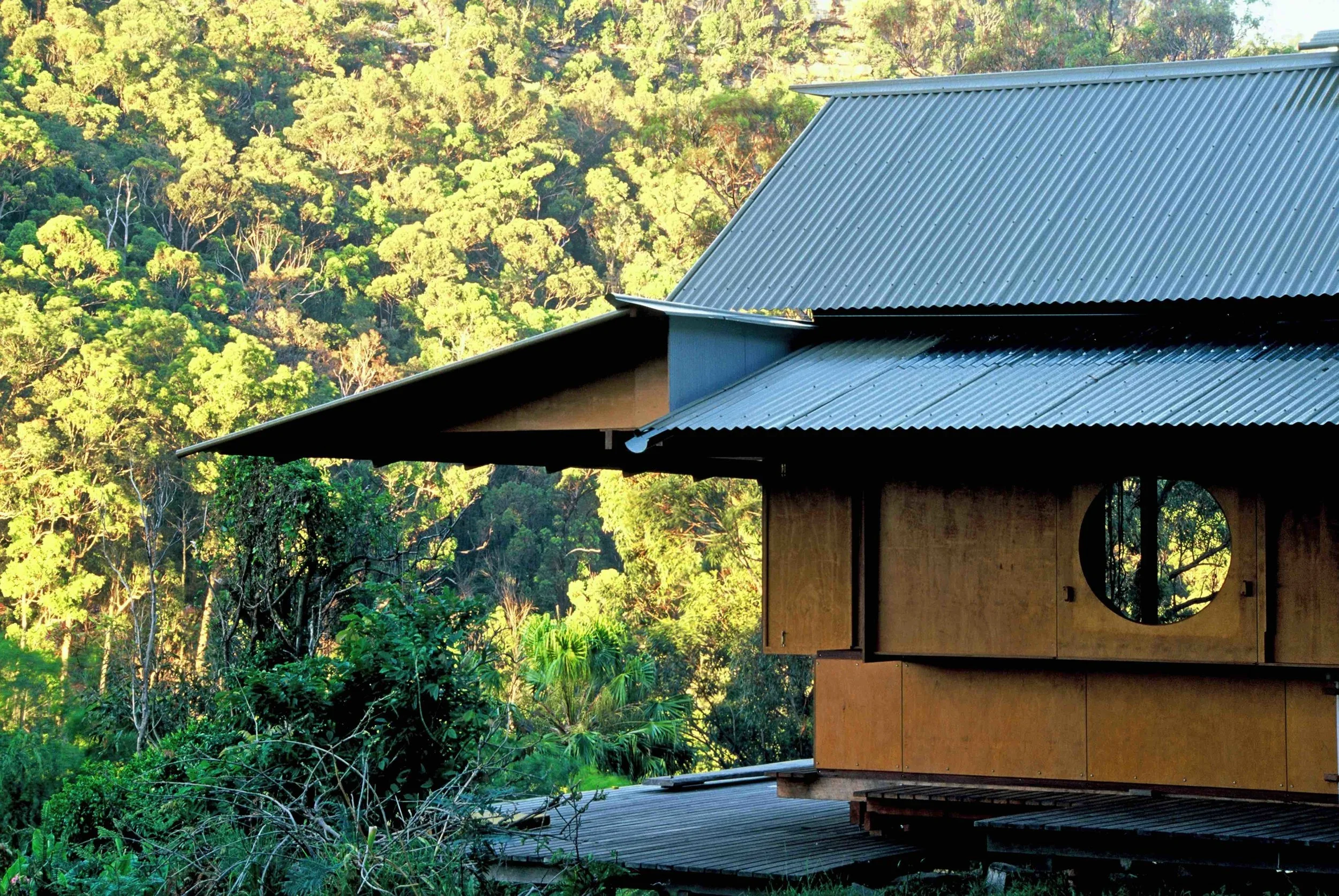 Lovett Bay House by Richard Leplastrier, showing the lightweight timber structure, corrugated roof and bushland setting in Pittwater, Sydney.