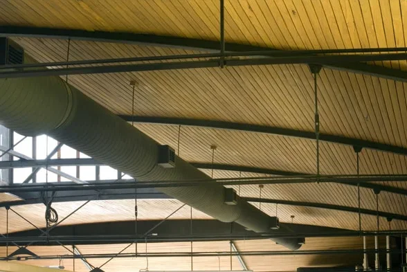 Ceiling with wooden panels, exposed ductwork, and structural beams.