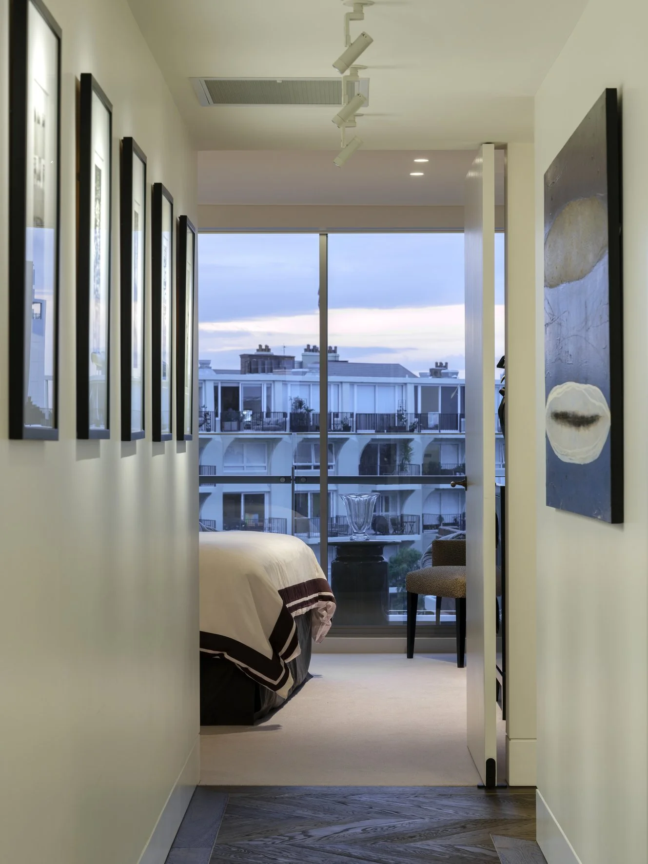 Potts Point Unit 2024 — high-end apartment renovation in Sydney featuring bespoke joinery, herringbone timber flooring with brass inlay, integrated lighting and a cohesive open-plan kitchen, living and dining space.