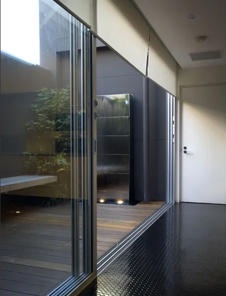 Modern indoor space with sliding glass doors, a closet, and a door leading outside.
