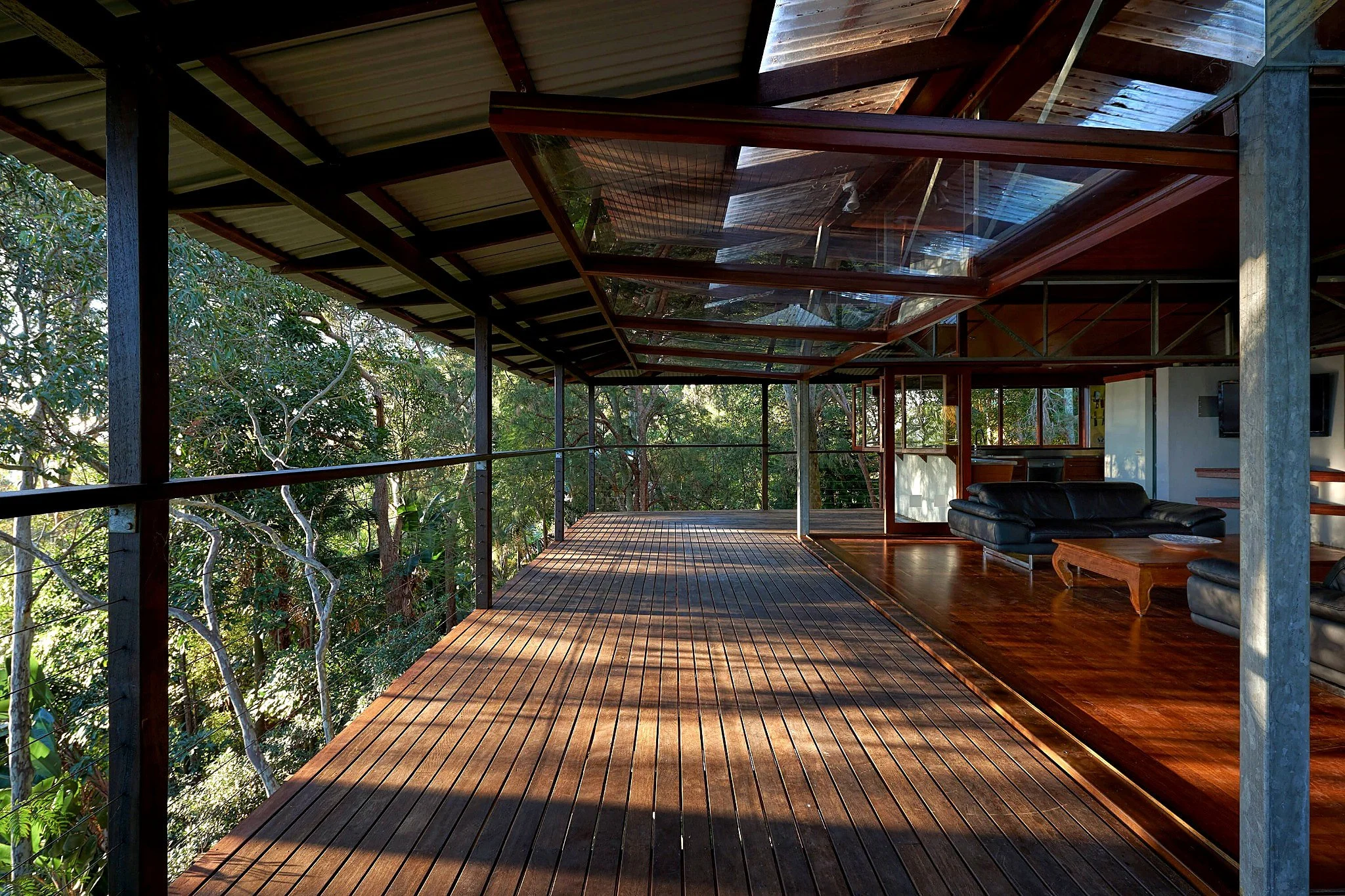 Elevated timber terraces and lightweight living spaces extending from Tree Top House into the surrounding canopy.