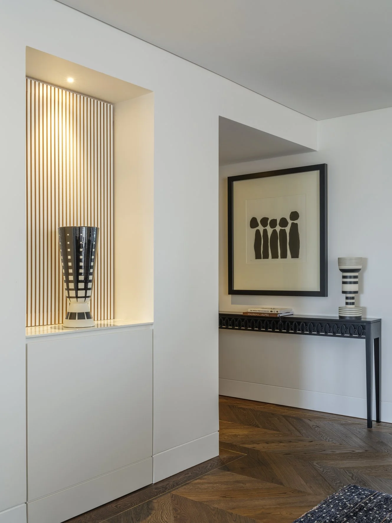 Potts Point Unit 2024 — high-end apartment renovation in Sydney featuring bespoke joinery, herringbone timber flooring with brass inlay, integrated lighting and a cohesive open-plan kitchen, living and dining space.