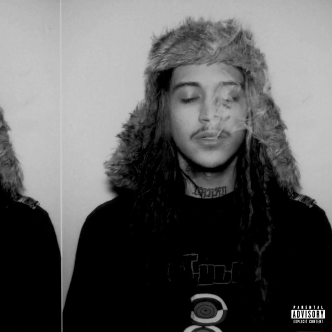 Black and white photo of a young man with long hair, closed eyes, a mustache, and a tattoo on his neck, wearing a fur-lined hat and a dark shirt with a Pokéball graphic.